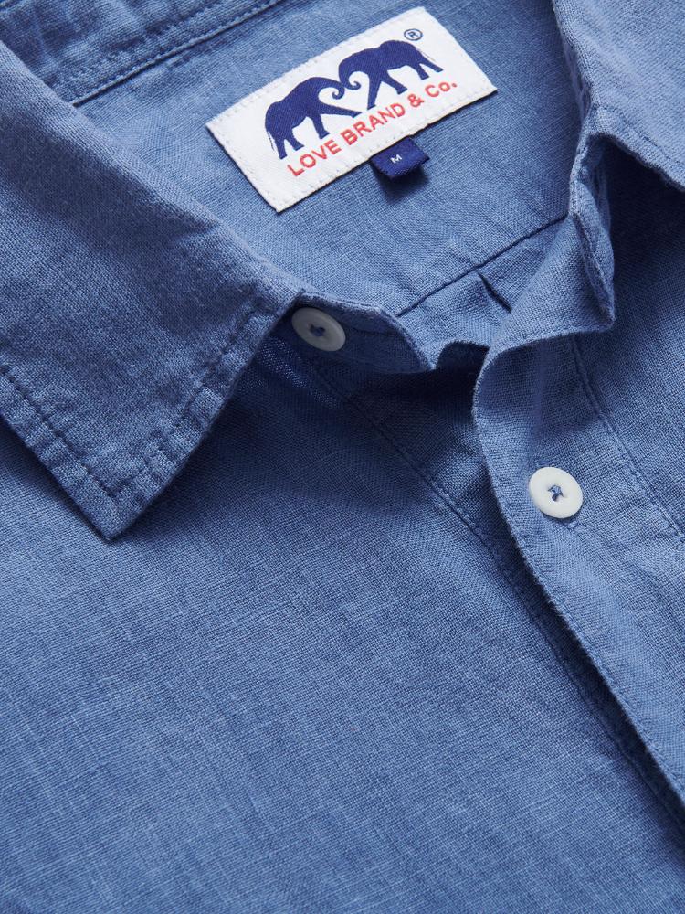 Men's Deep Blue Hoffman Linen Shirt made from 100% natural linen, showcasing a classic collar and white buttons with a brand label.