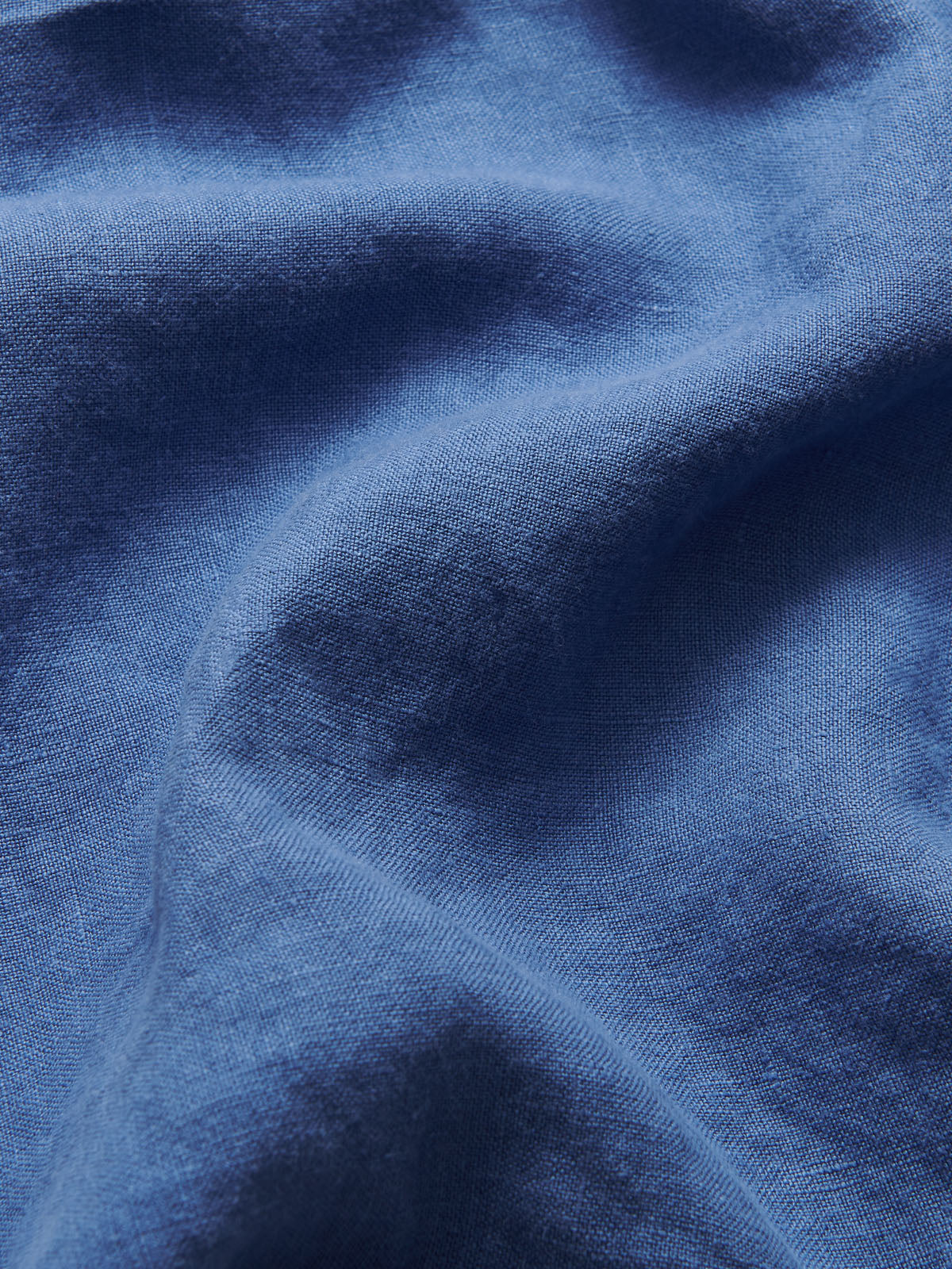 Detailed view of Men's Deep Blue Joulter Linen Shorts. Blue linen shorts with a drawstring waist and 2 front pockets.