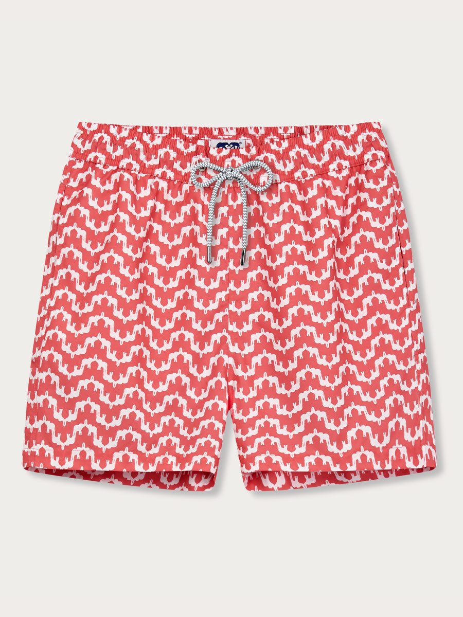 Boys swim shorts with Elephant Palace print in Coral Rose, featuring white elephant designs with trunks up creating a palace-like pattern, inspired by Indian jungles and conservation efforts.