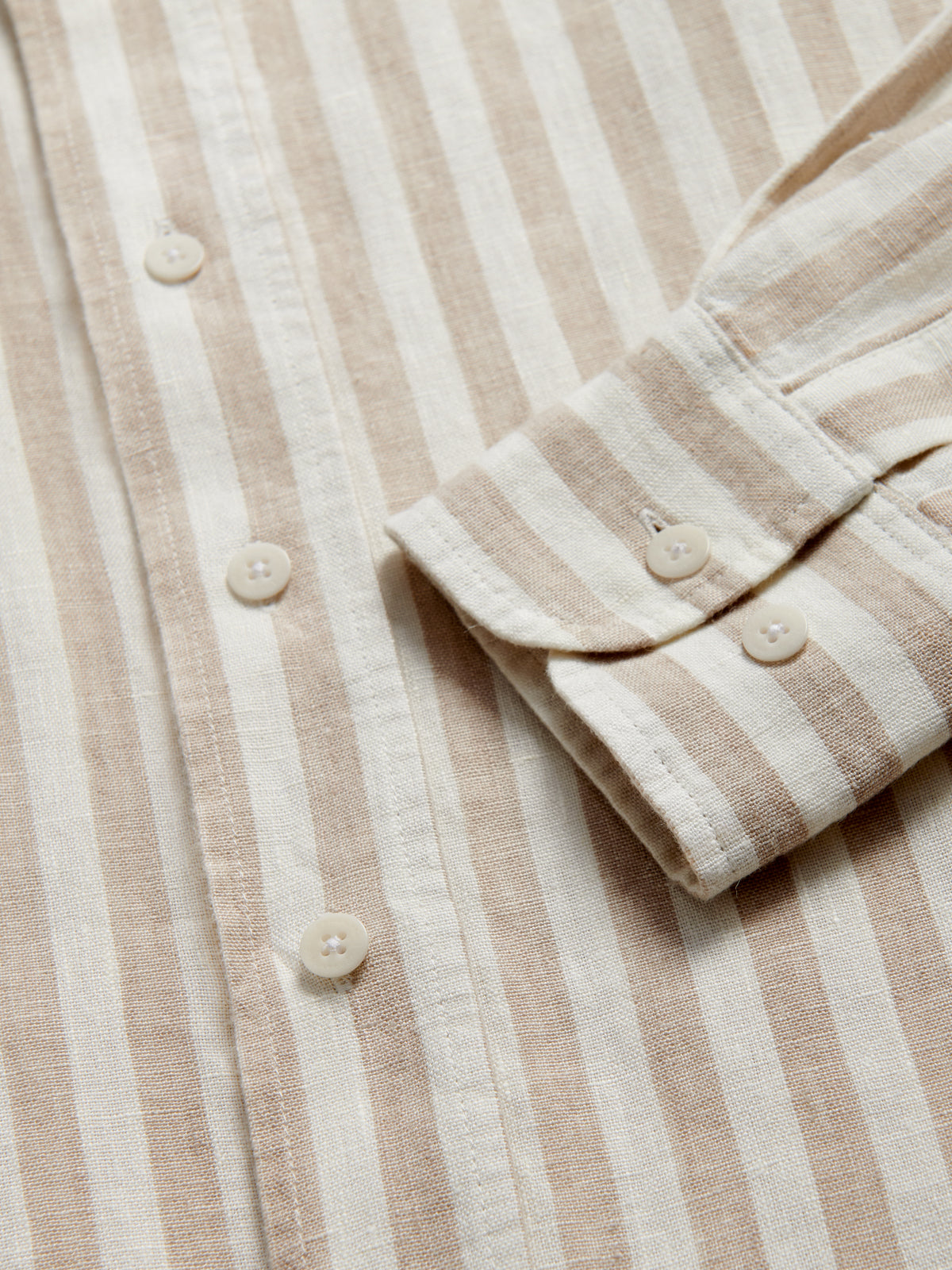 Close-up cuff view of Men's Coconut Stripe Abaco Linen Shirt showing brown and white striped pattern.