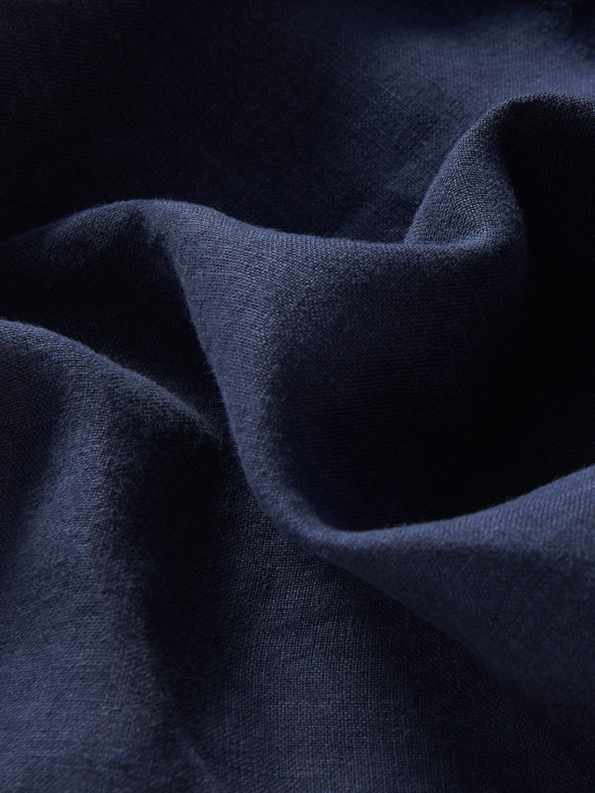 Detailed view of Men's Navy Blue Joulter Linen Shorts. Blue linen shorts with 2 front pockets and drawstring waist.