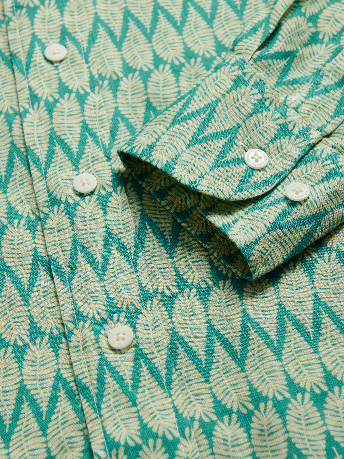Close-up cuff view of Men's Paradise Abaco Linen Shirt. Men's green shirt cuffs.