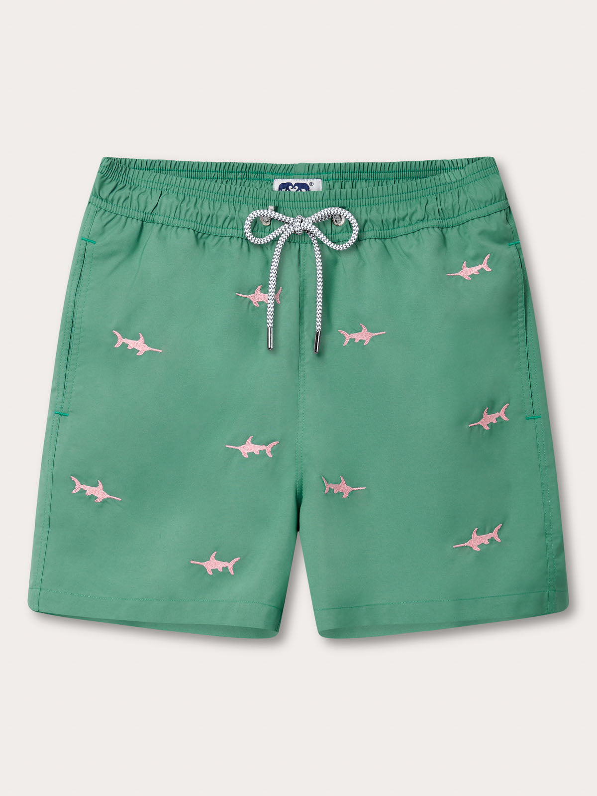 Changing of the Guards Staniel mens Swim Shorts. Embroidered swim shorts with pink swordfish motifs on green fabric. Crafted exclusively for Harrods.