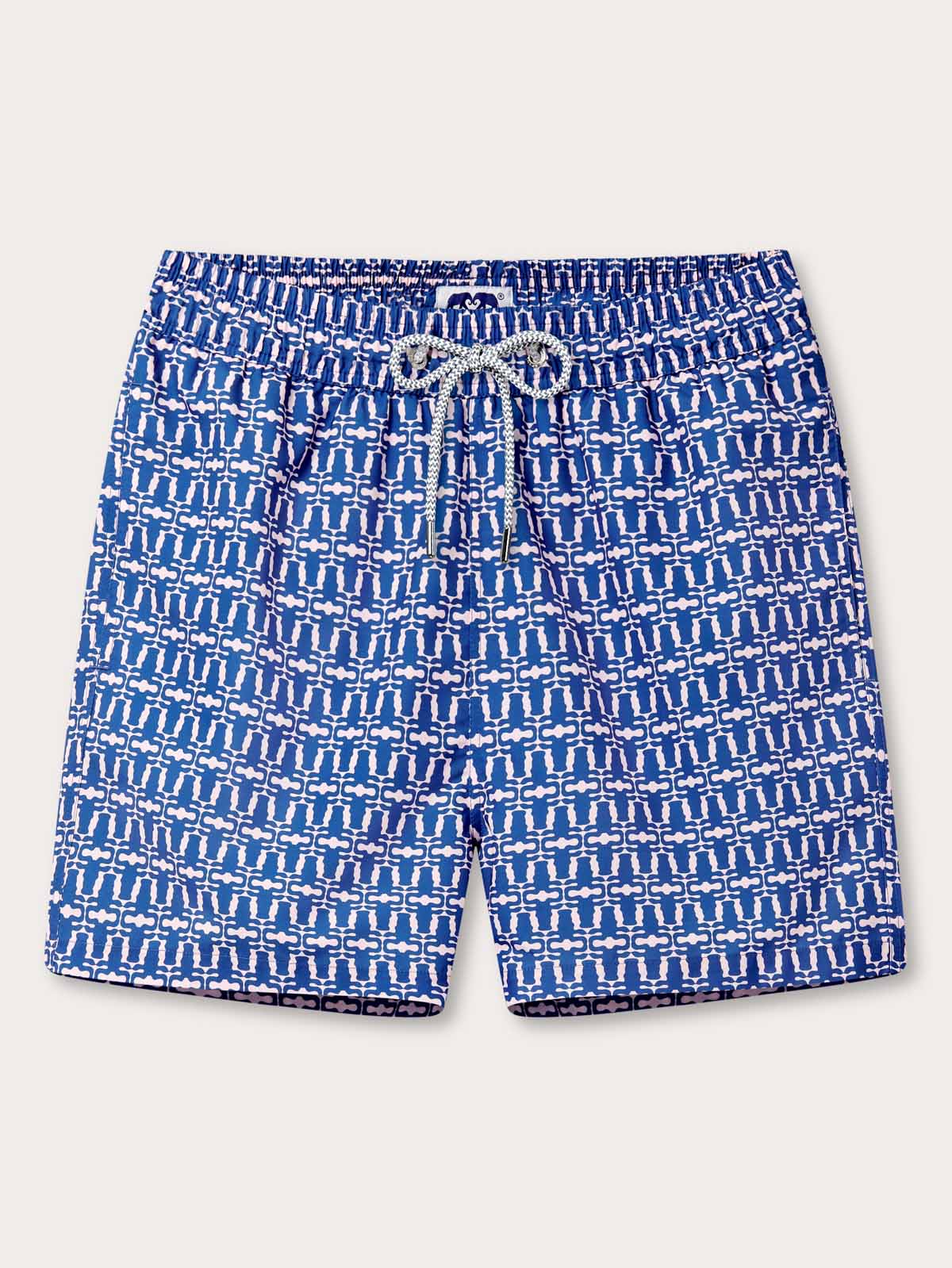 Wilderness Staniel mens Swim Shorts. Patterned swim shorts featuring a pastel pink pattern on a blue background.