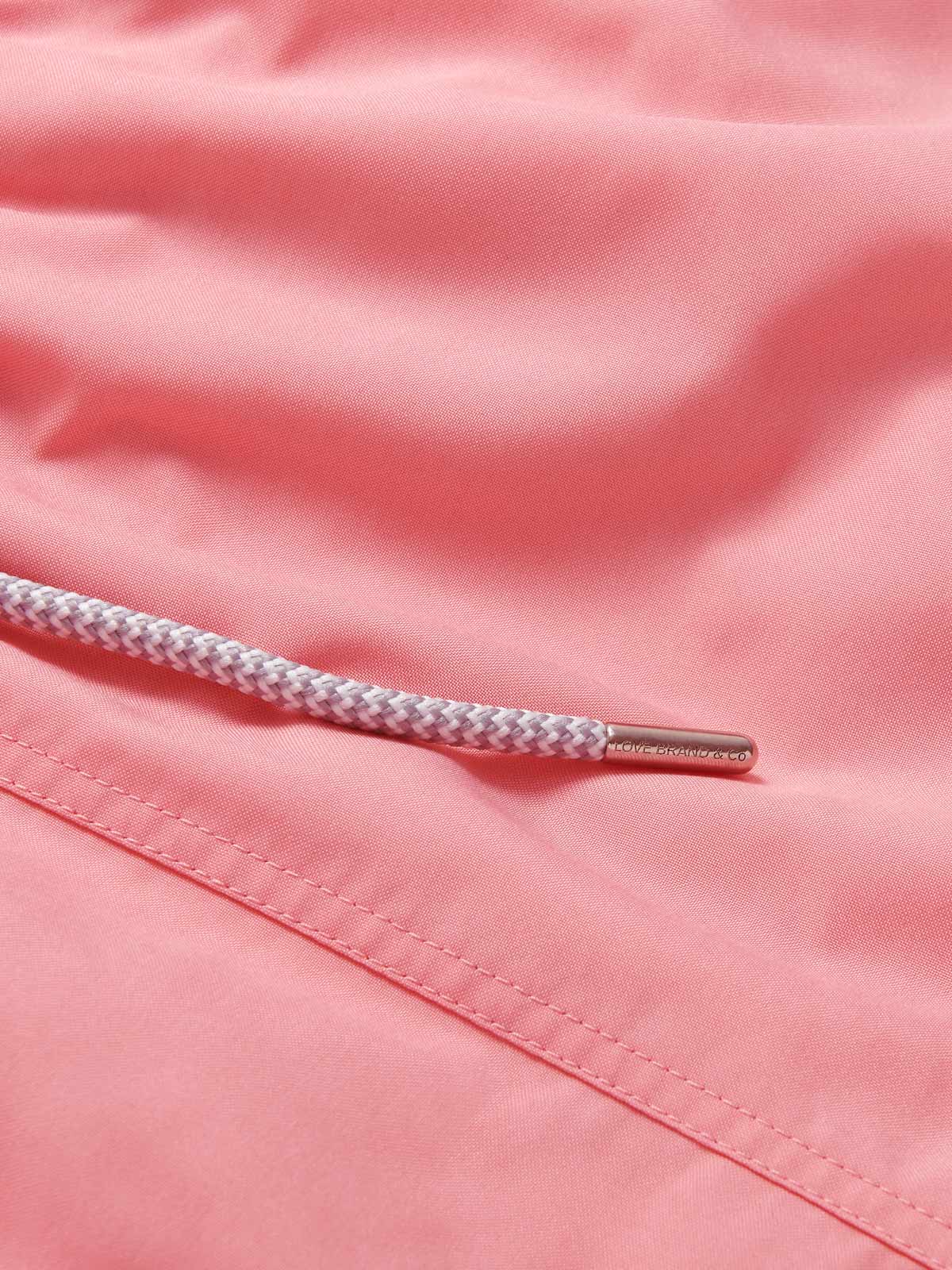 Close-up view of mens watermelon pink swimming shorts