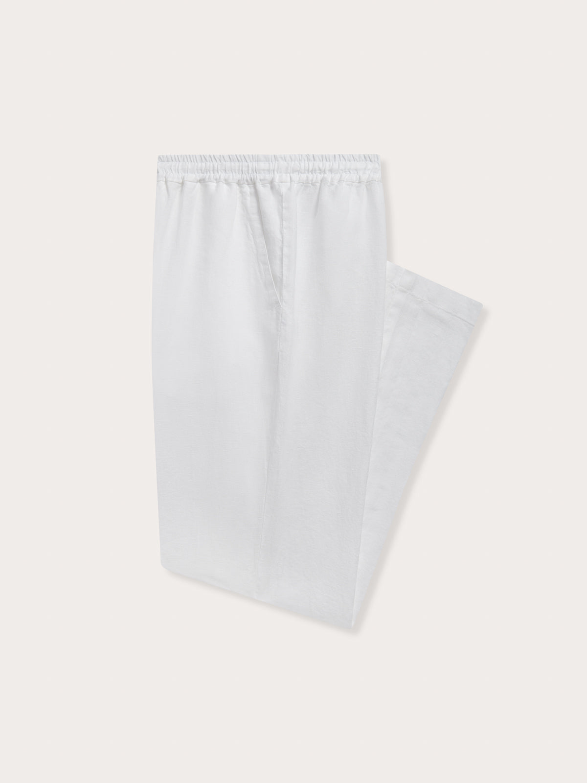 Detailed view of Men's White Eleuthera Linen Trousers. Classic white linen pants for men with drawstring waist and 2 handy pockets.