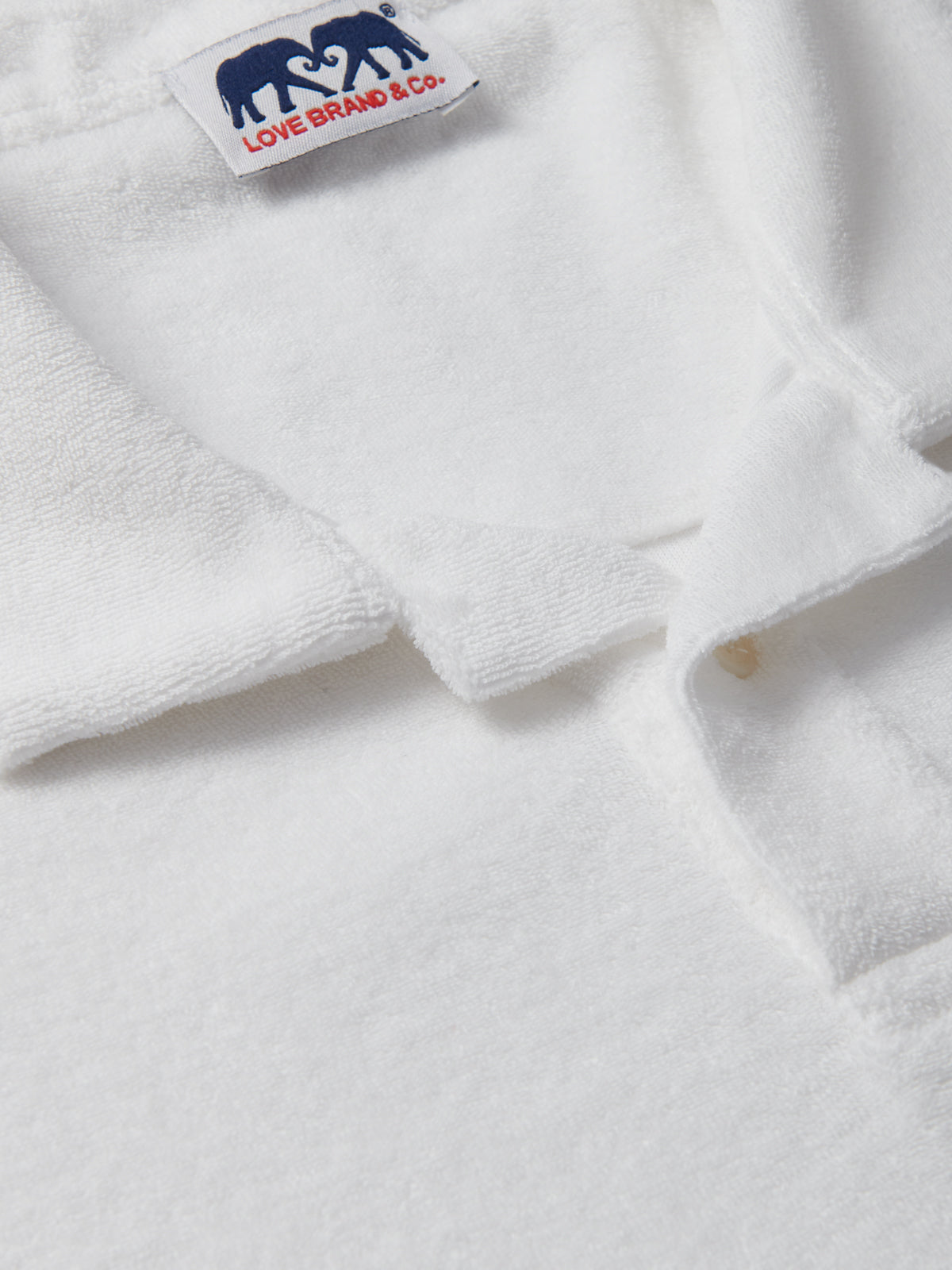 Mens White Terry towelling Polo Shirt close-up of cotton terry towelling fabric.