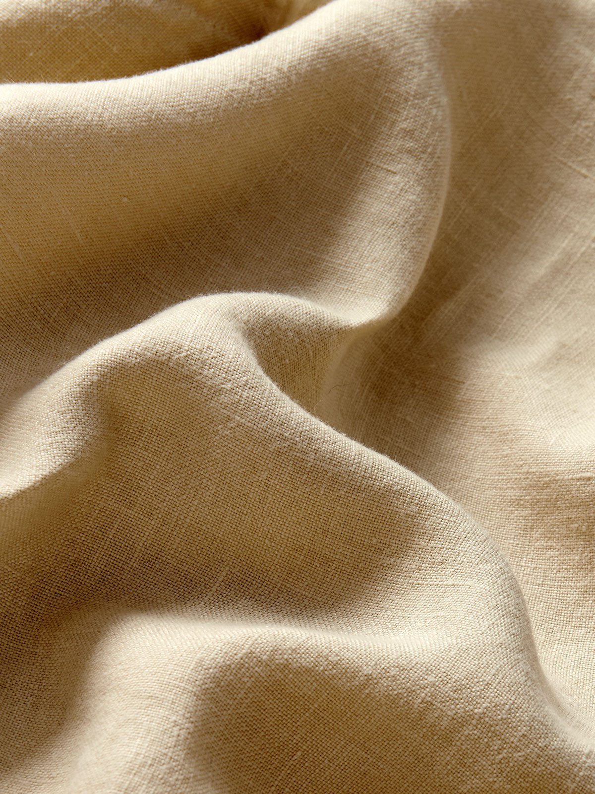 Close-up view of Men's Coconut Joulter Linen Shorts. Classic brown shorts with 2 front pockets and a drawstring waist in a relaxed fit.