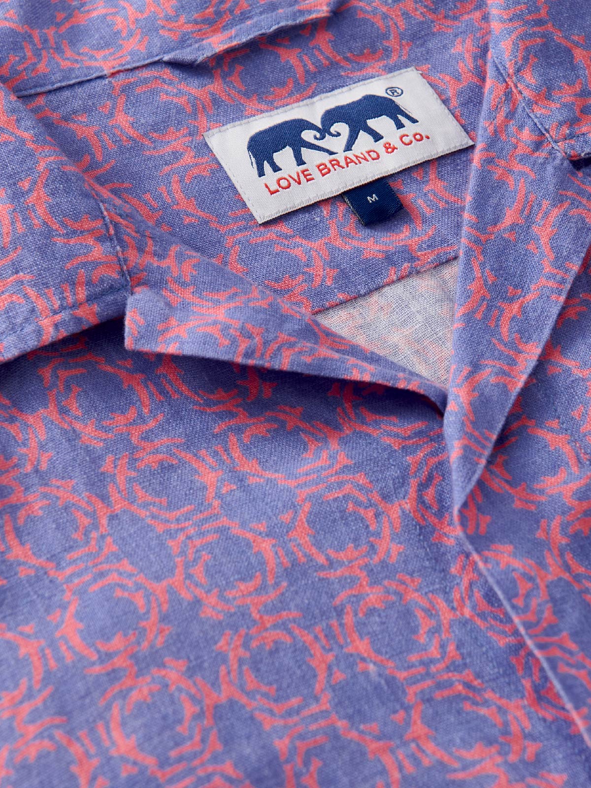 Close-up of a patterned shirt with a visible love brand label.