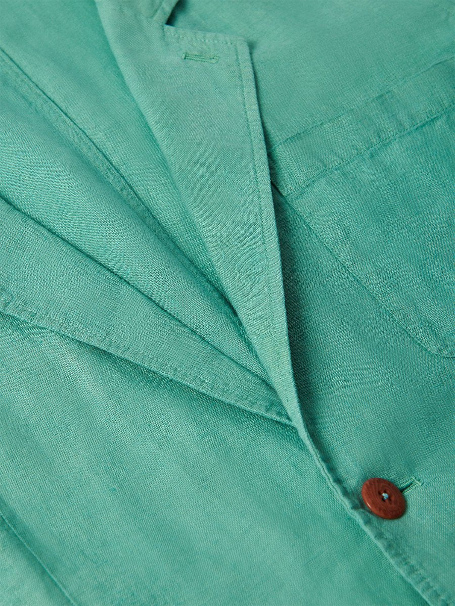 Men's Riviera Green Nassau Linen Jacket showcasing corozo nut button and lightweight linen material details. Men's linen jacket in a relaxed fit.