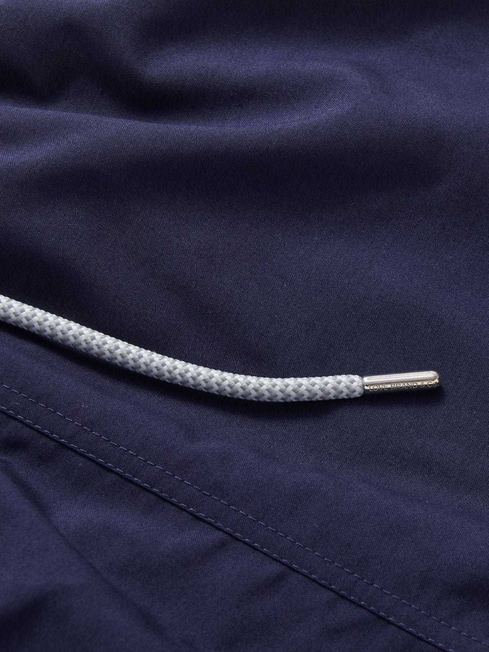 Men's Navy Blue Staniel Swim Shorts detailed view. Close-up of the navy blue fabric of these plain blue swimming shorts mens.