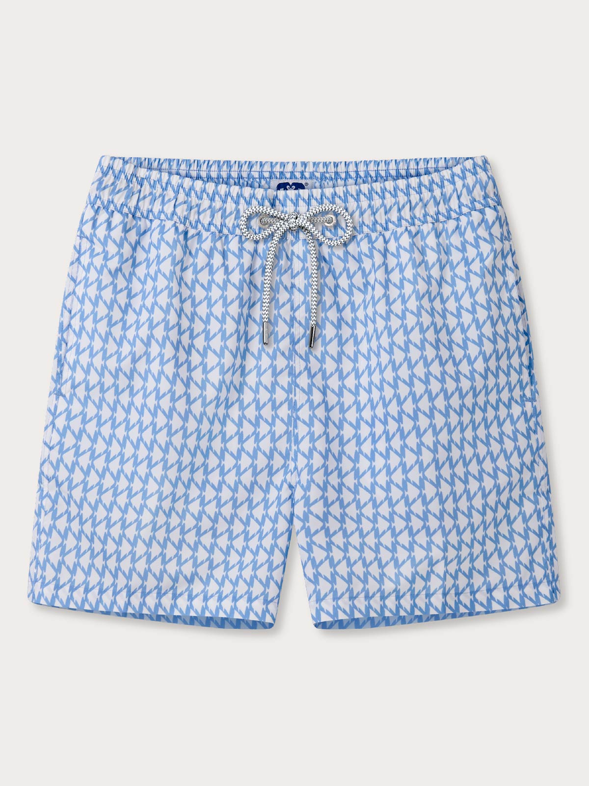 white and blue swimming shorts with a pattern of angel fish