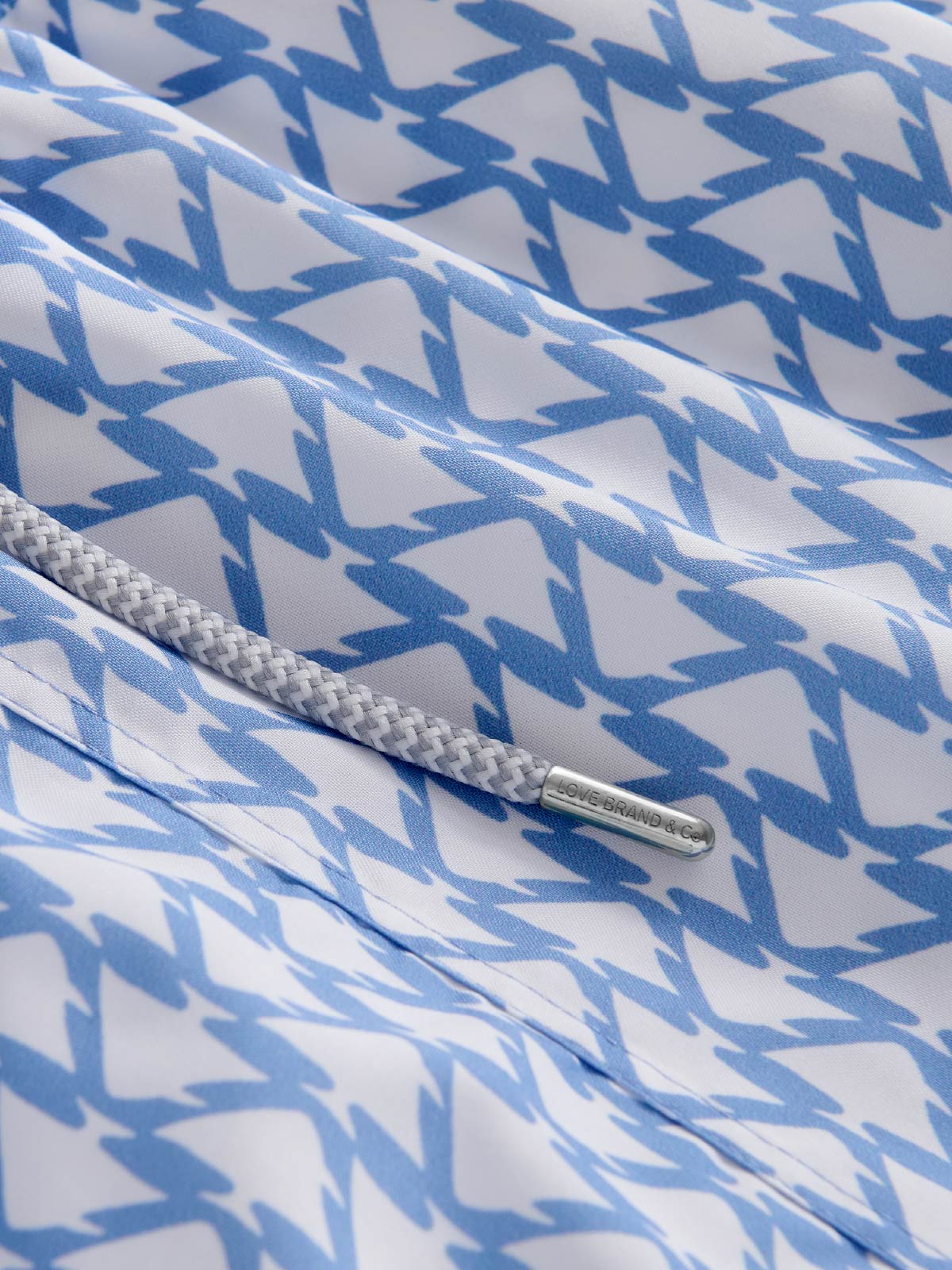 Close-up of a blue and white patterned fabric with a drawstring.
