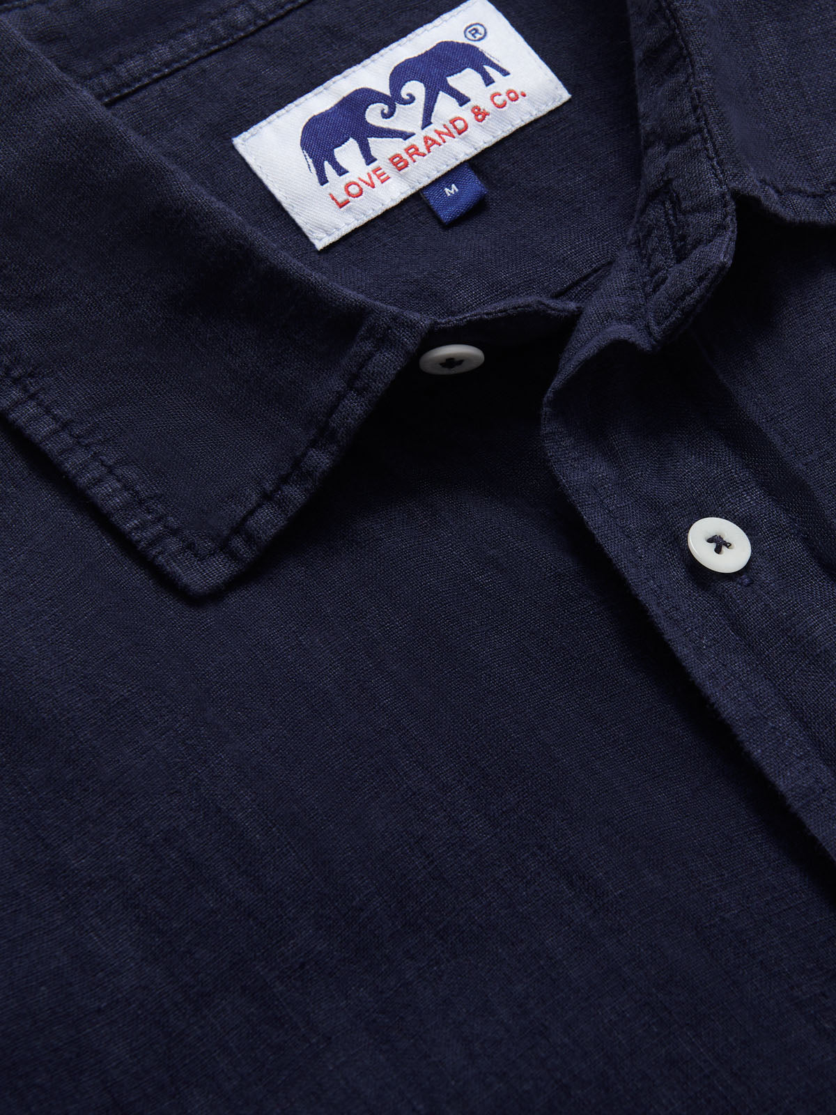 Navy Blue Manjack mens Linen Shirt close-up showing collar, buttons, and Love Brand & Co. label. Old money shirts crafted from 100% linen.