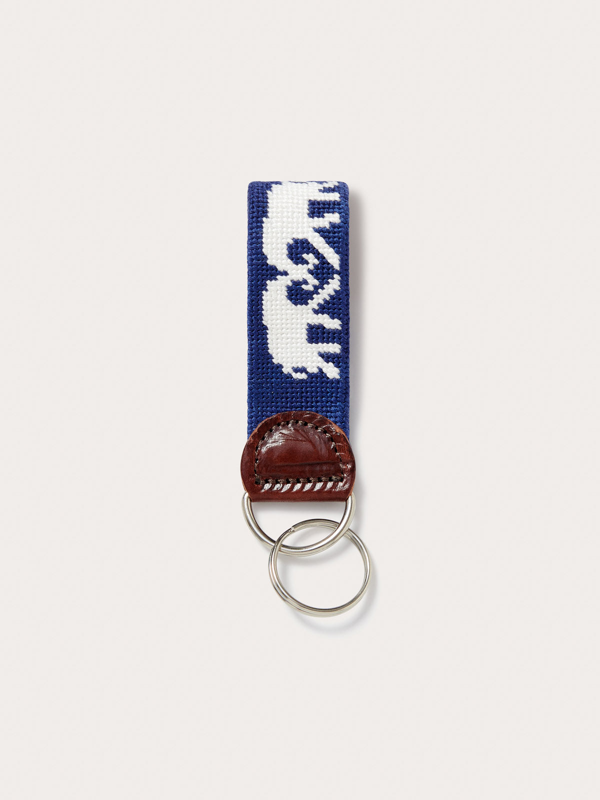 Navy blue elephant key chain featuring love brand logo.