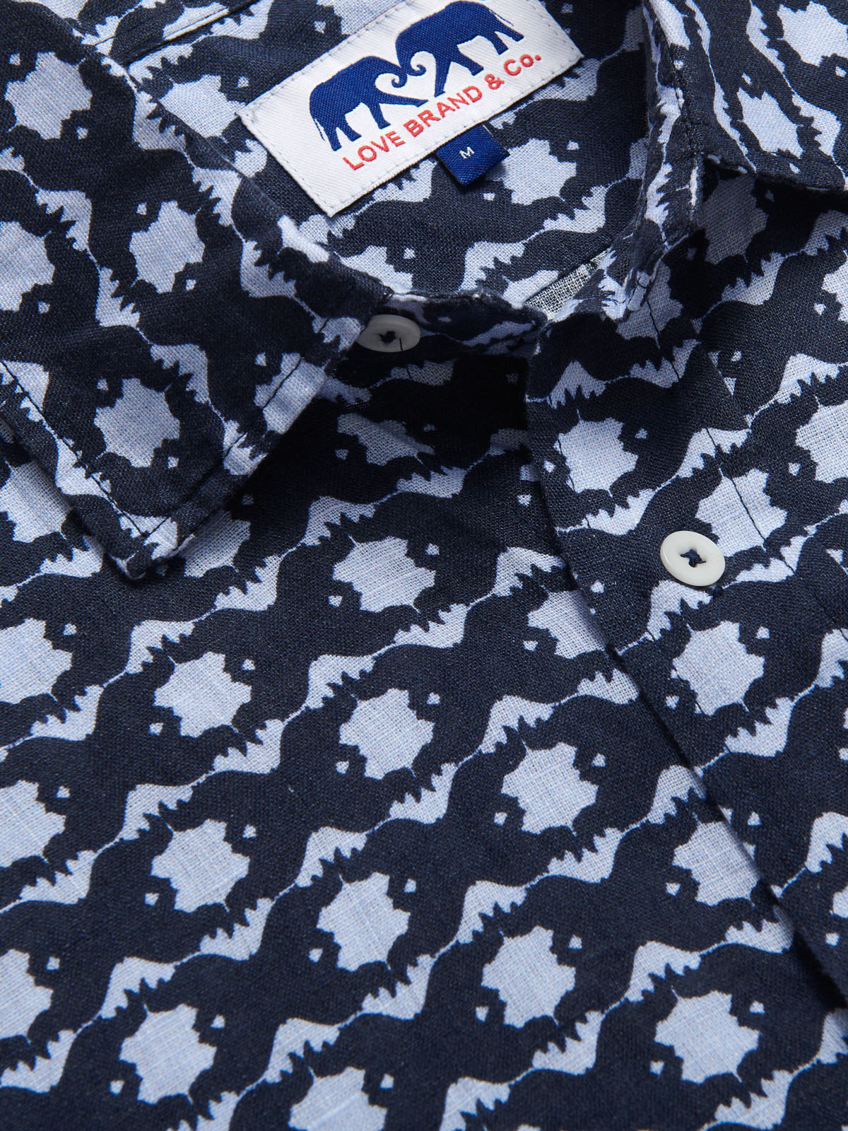 close-up view Rhino Rhythm Abaco mens Linen Shirt. Showingcasing blue rhino pattern.