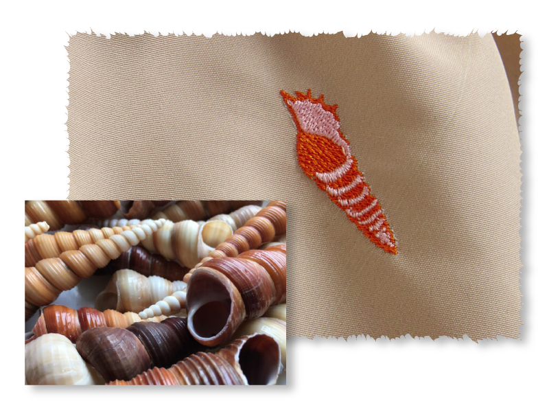 shellebration embroidery pattern. Red shells on brown fabric.