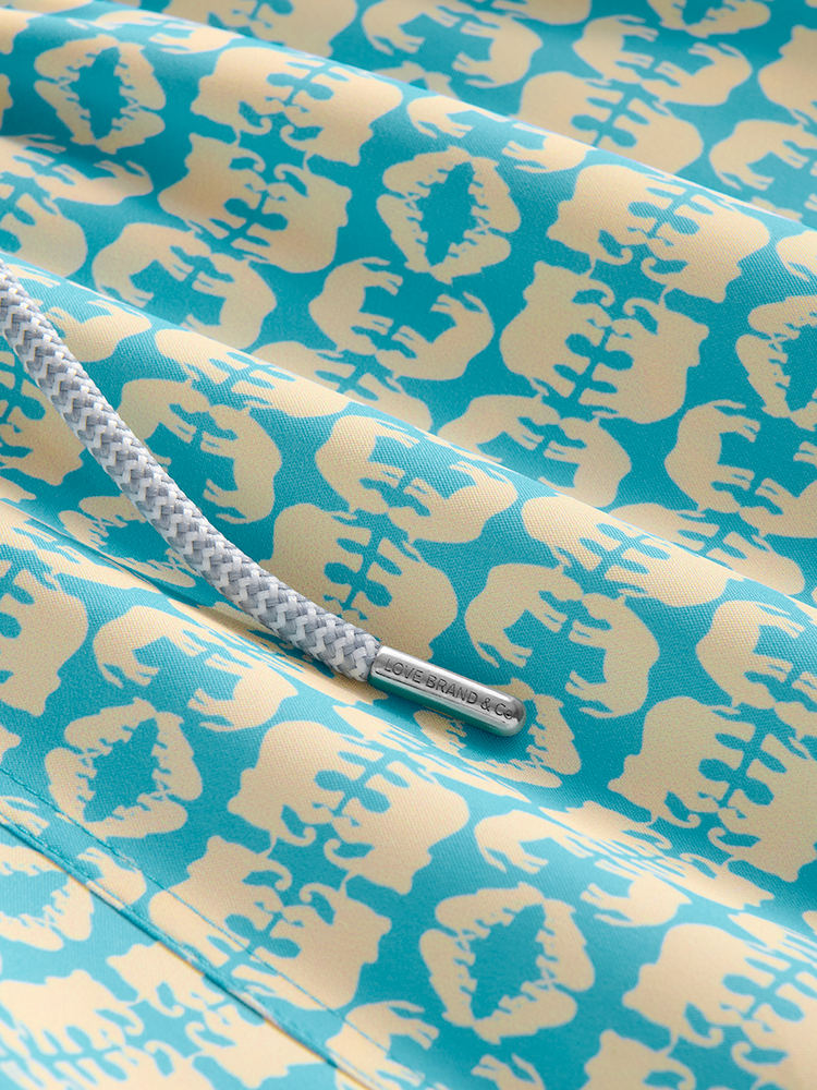 Close-up of blue and yellow patterned swim trunks with a drawstring
