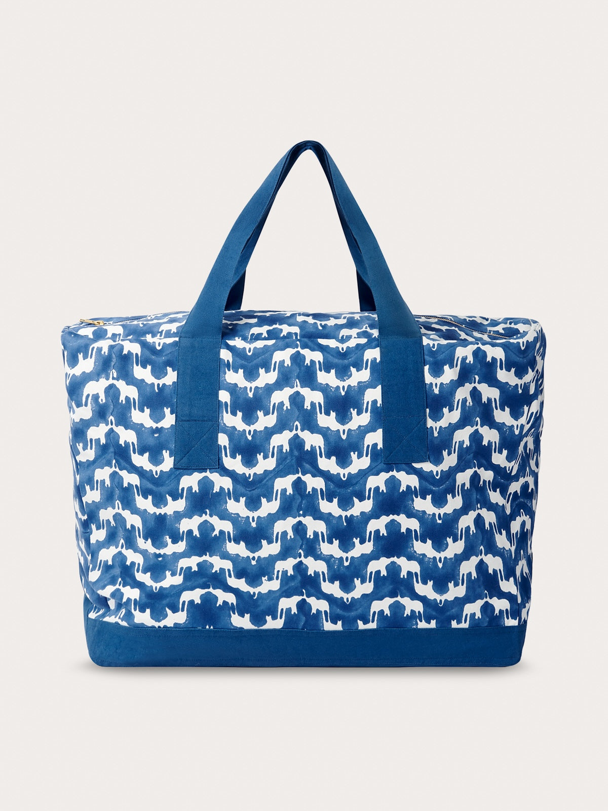 A medium-sized blue canvas tote bag with a block-printed elephant design and a solid blue color.