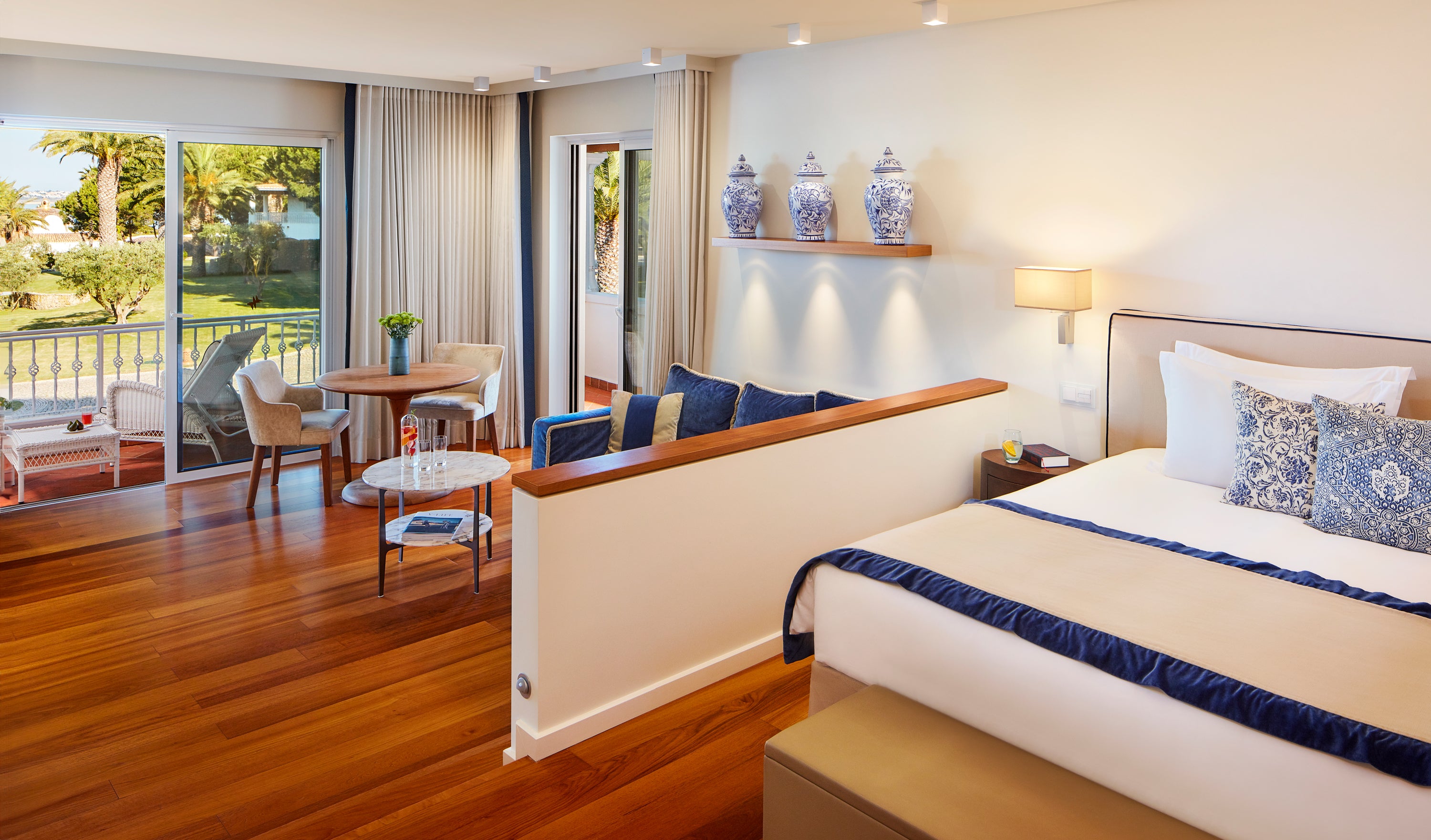 Bedroom at Vila Vita with a large bed, wooden floor, and balcony view.