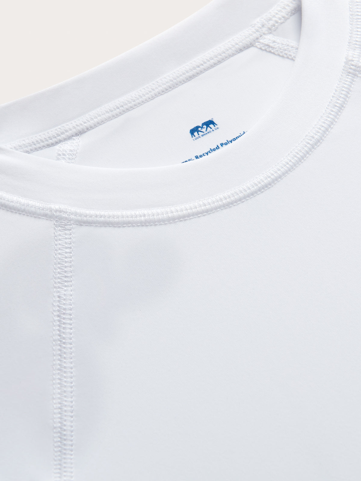 Close-up view of Kids White Harbour Rash Guard. Long-sleeved white rash vest for kids.