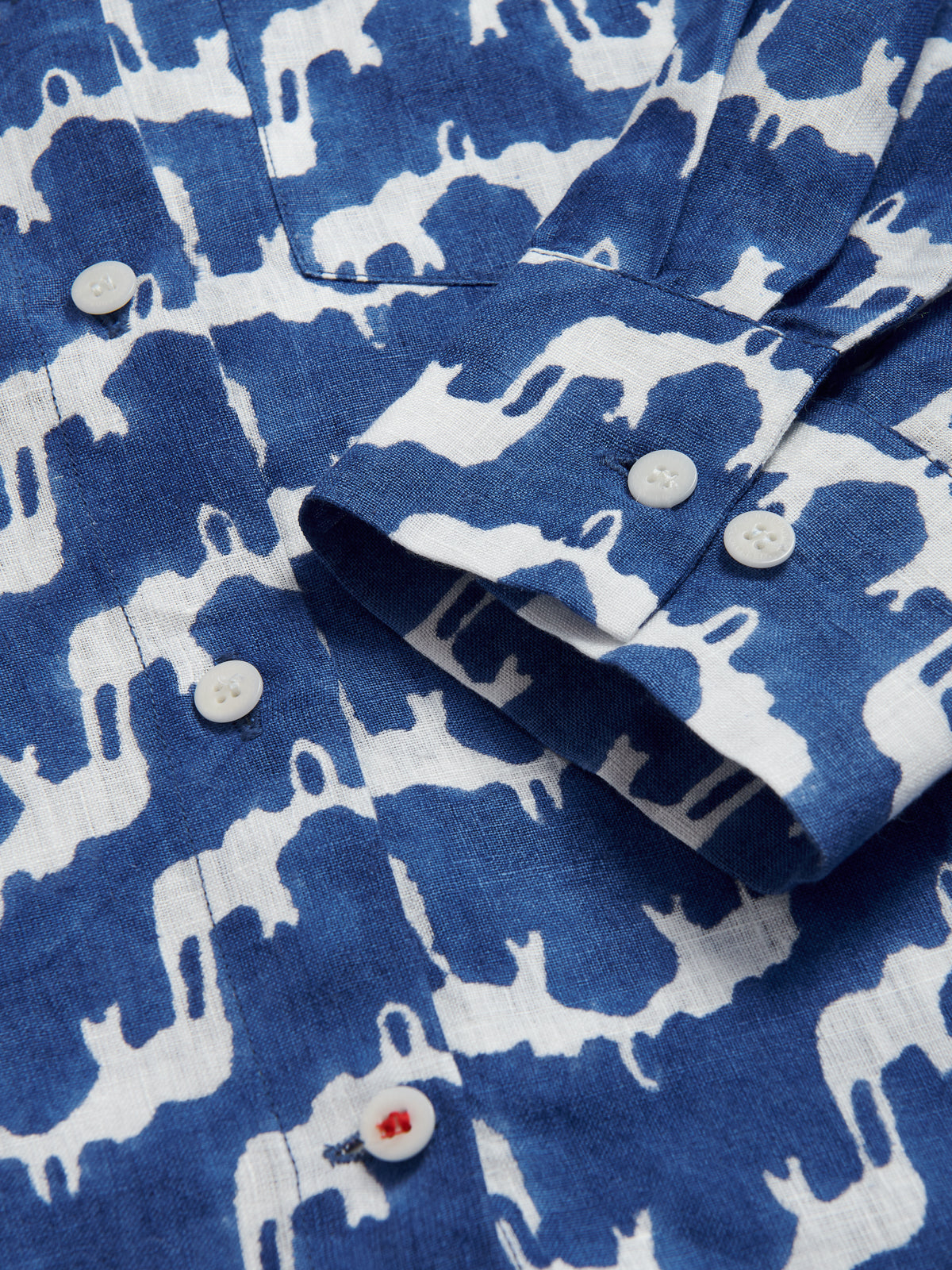 Deatield view of Womens Elephant Palace Blue Inagua Linen Shirt. Long-sleeved button-up linen shirt with front pocket. Blue and white shirt in our bestselling elephant palace blue print.