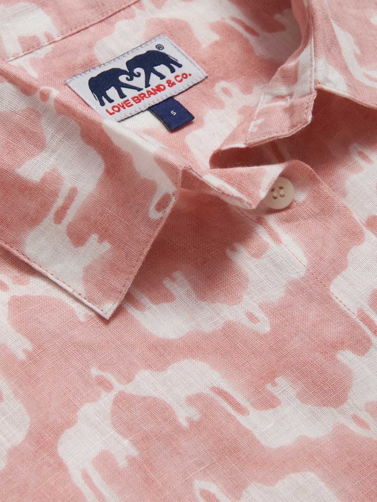 Close-up of our Womens Elephant Palace Strawberry Inagua Linen Shirt. Pink and white linen shirt with a handy front pocket. Finished with an allover elephant print.