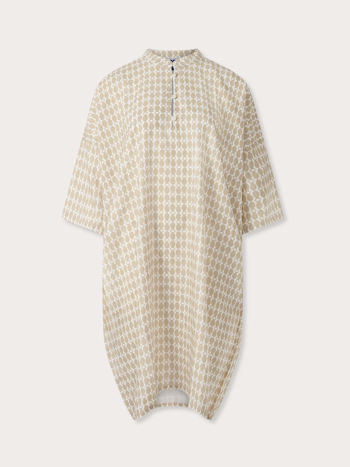 Brown poncho with a geometric pineapple pattern on a light grey background