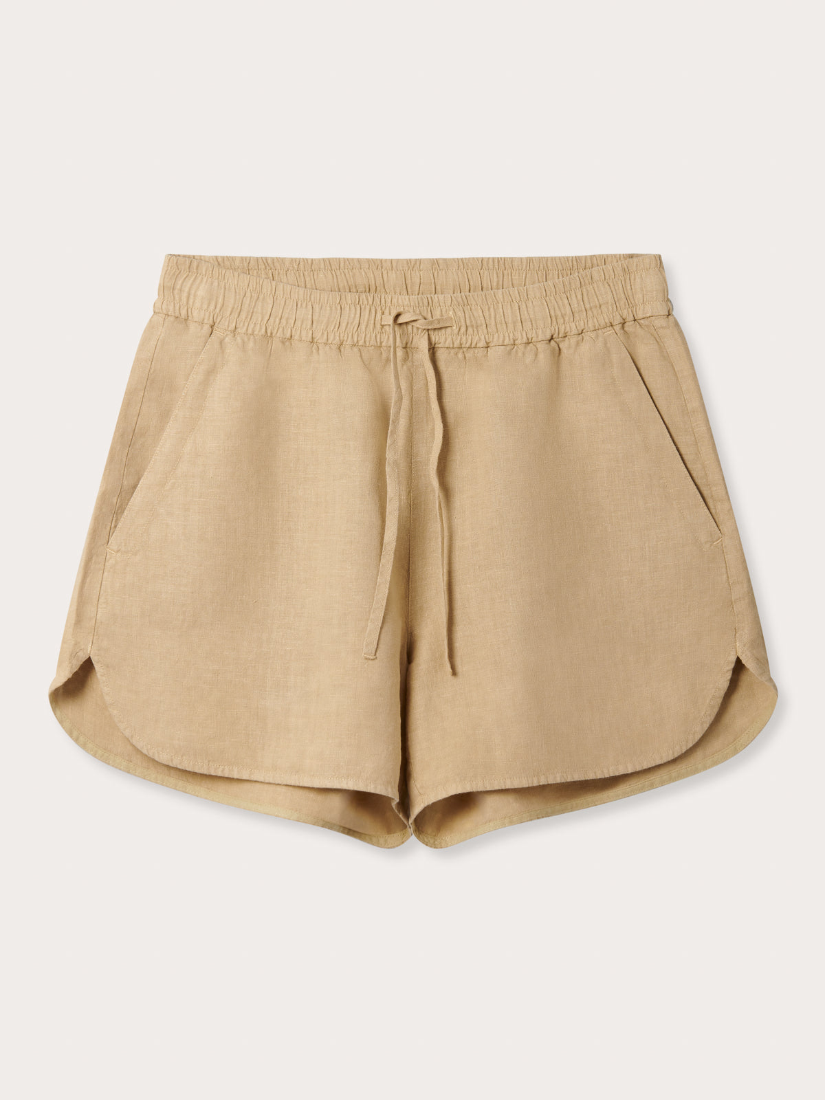 Front view of Womens Coconut Musha Linen Shorts. Beige linen shorts with 2 front pockets and drawstring waist in a relaxed fit.