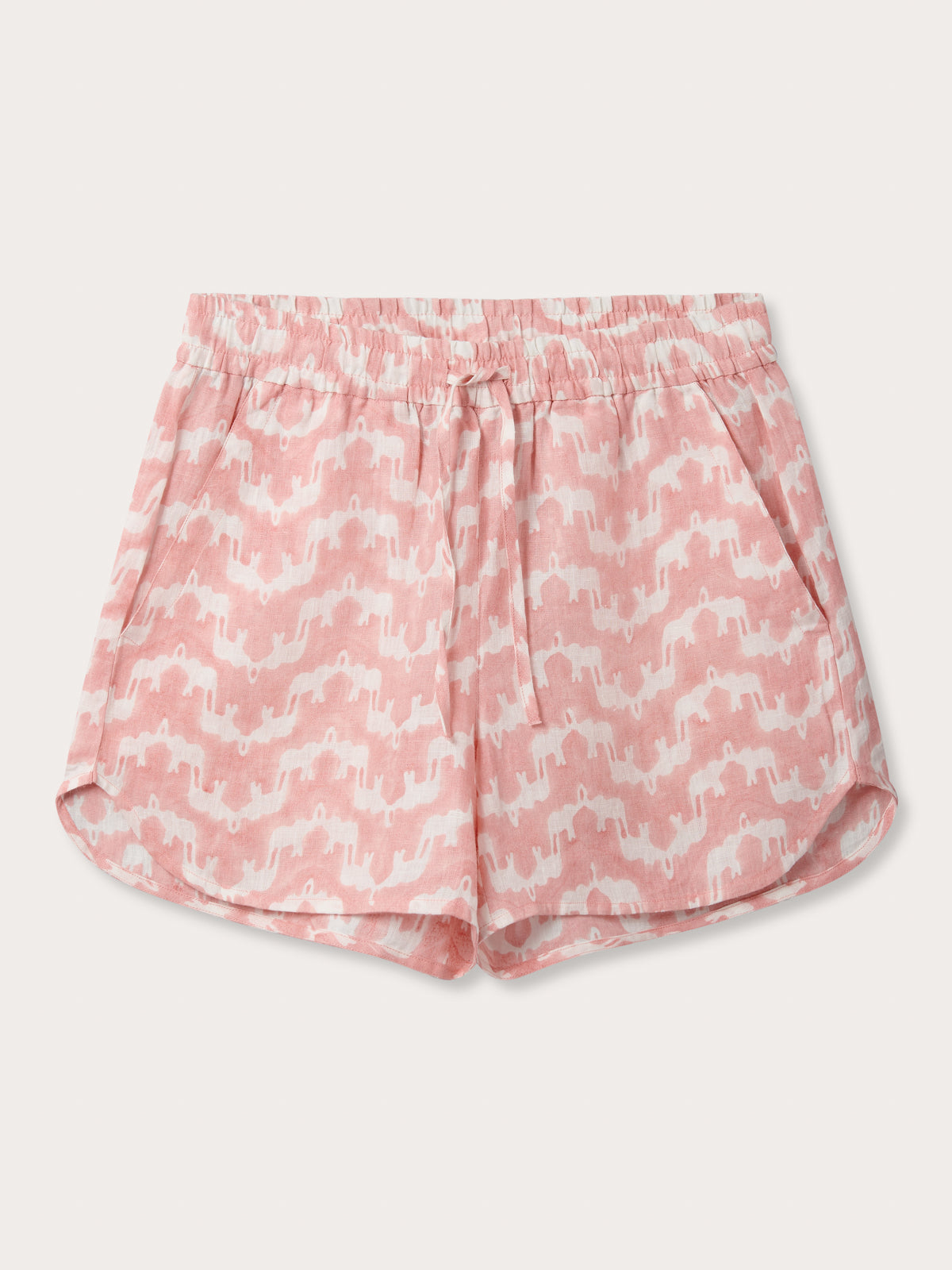 Front view of Womens Elephant Palace Strawberry Musha Linen Shorts. Pink and white shorts with elastic waist, drawstring and handy pockets. made from 100% linen hand block-printed by Indian artisans.