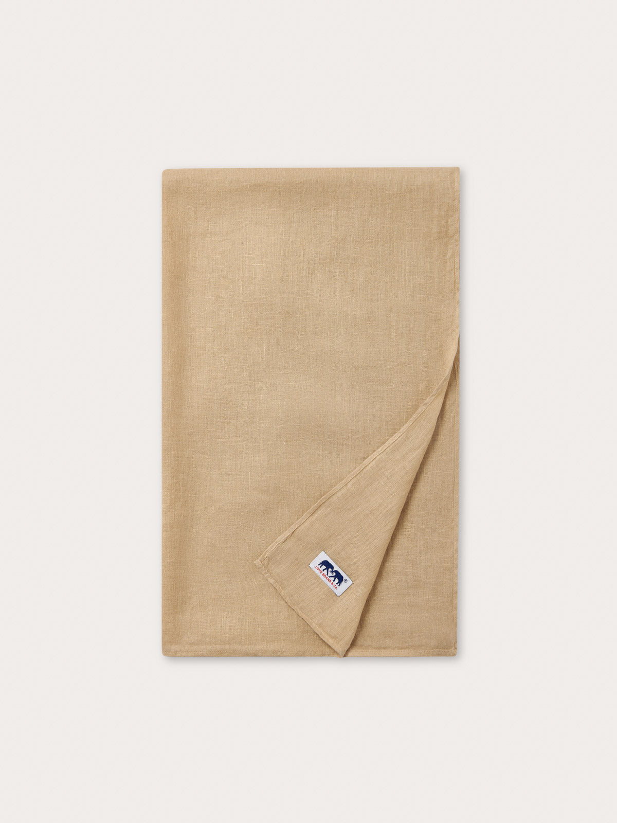 Close-up of 100% linen fabric showing beige plain fabric.