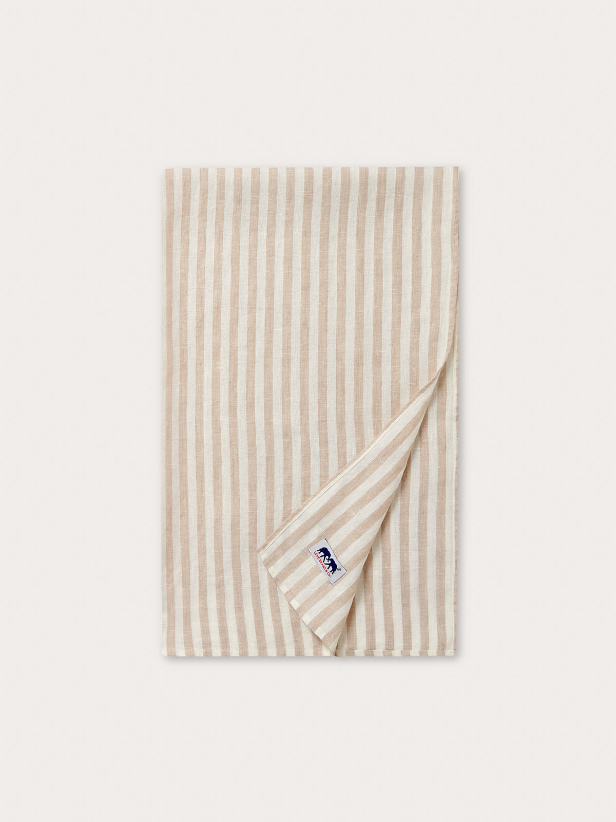 Close-up of 100% linen fabric showing beige and white striped patterned fabric.