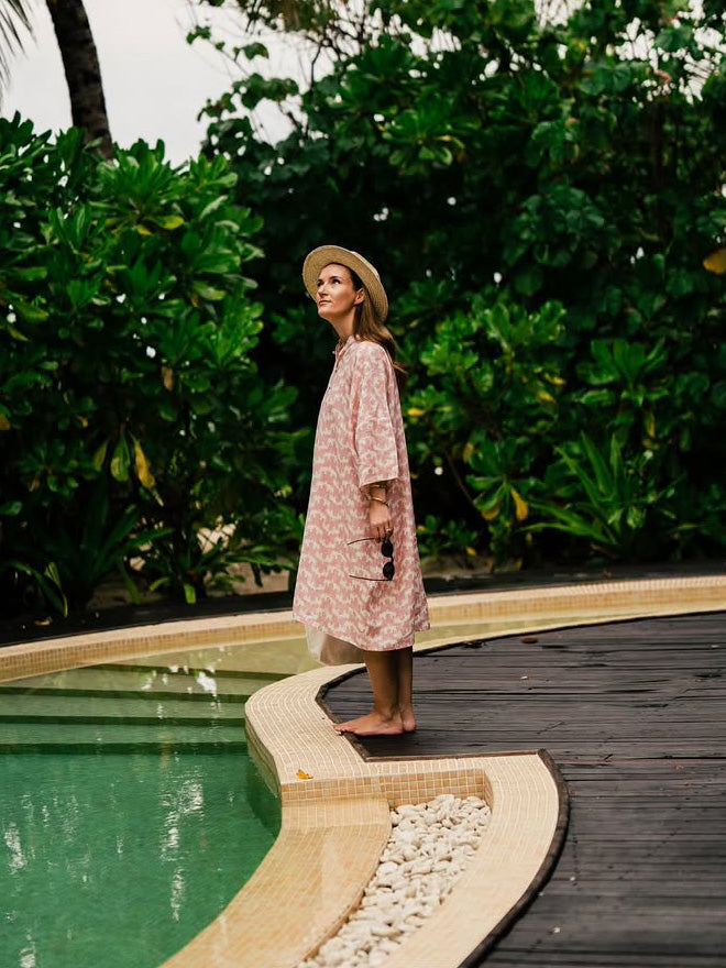 women wears swimsuit cover up by beachwear brand love brand & co.