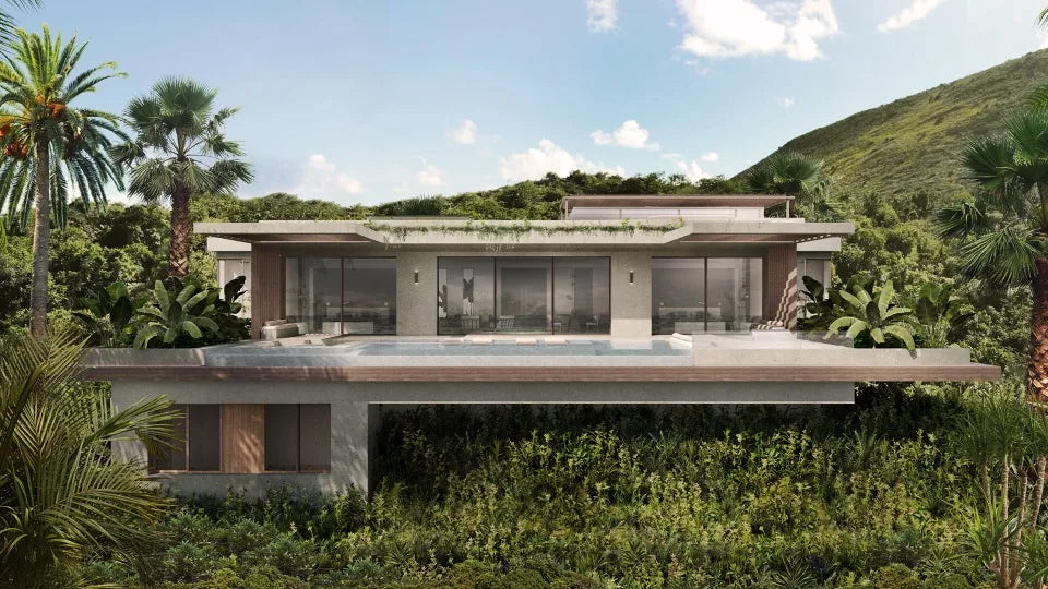 Modern house with a pool surrounded by greenery and mountains at Biras Creek Resort