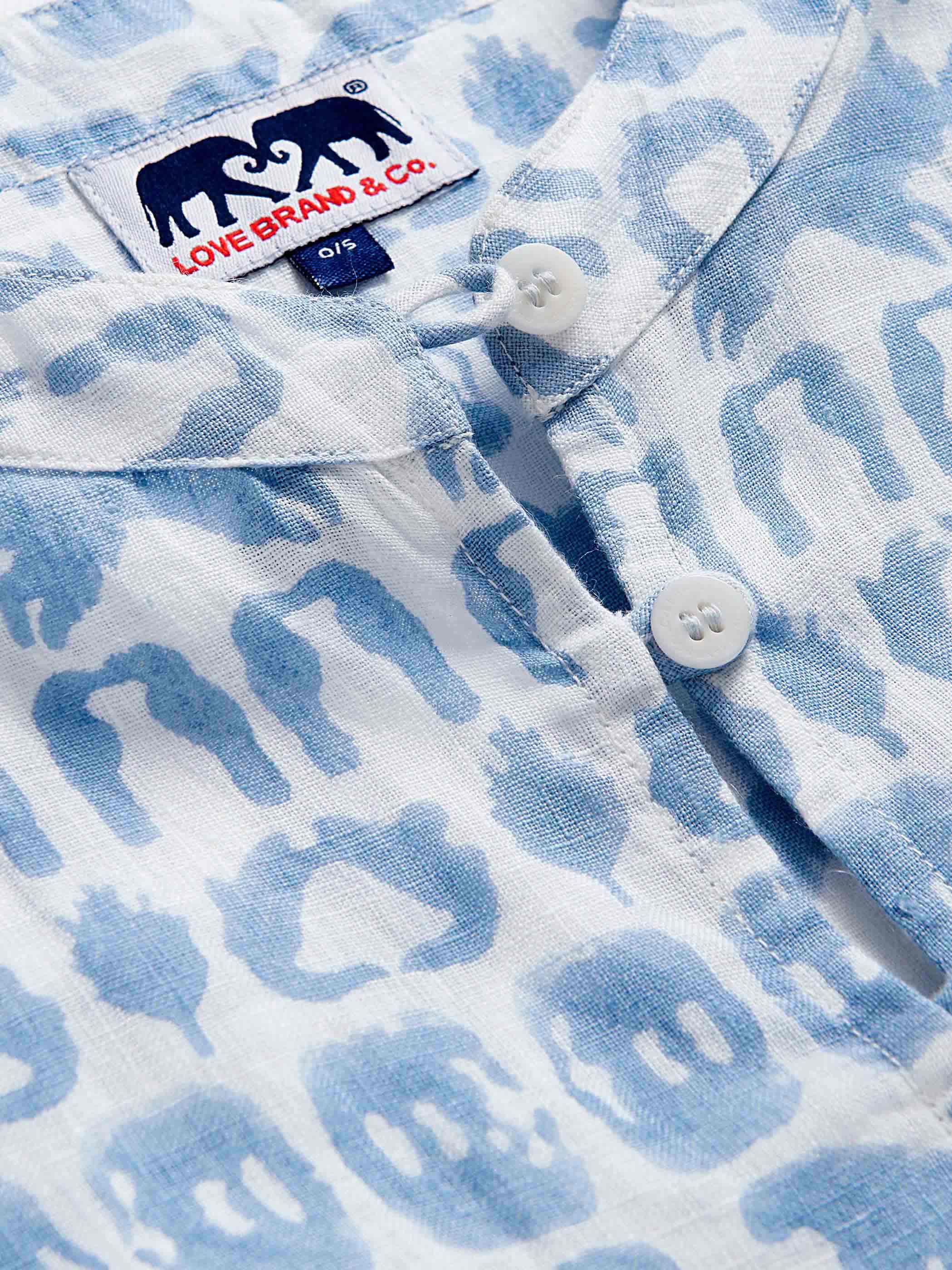 Close-up of blue and white poncho crafted from 100% linen