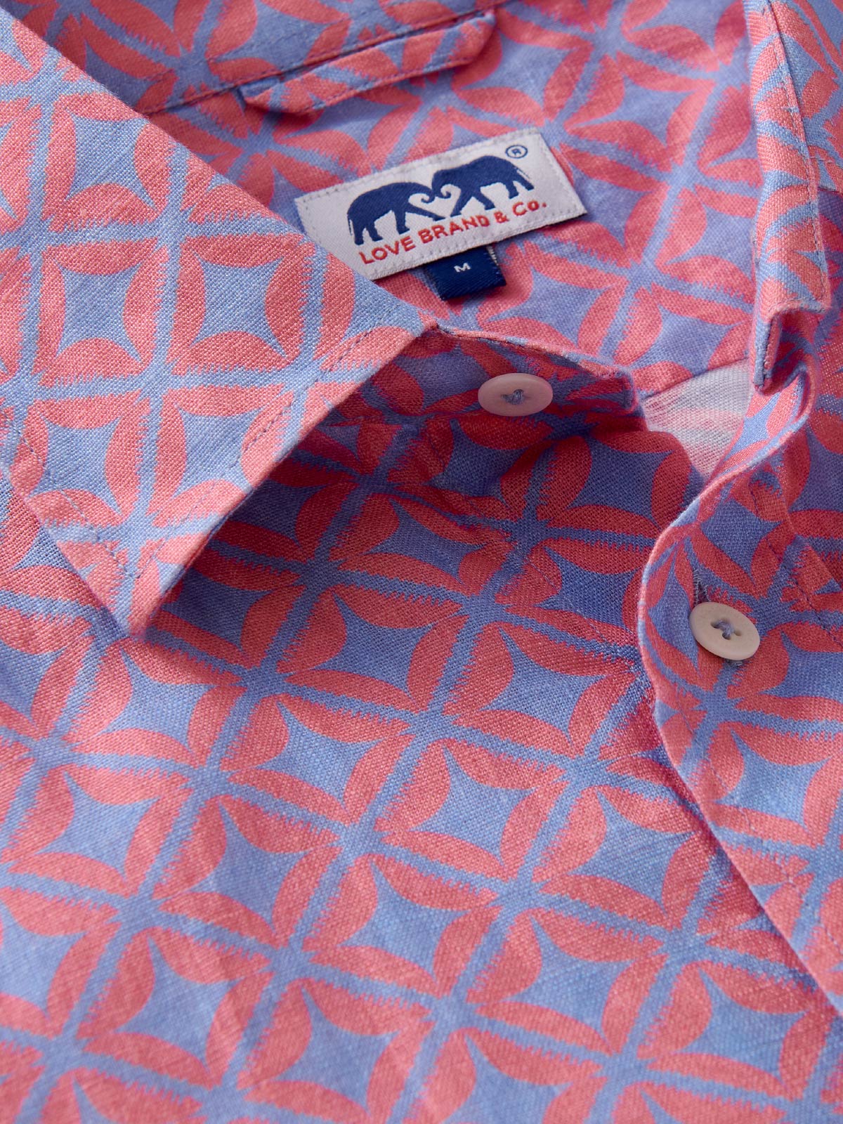 Close-up of a blue patterned shirt with a love brand label visible.