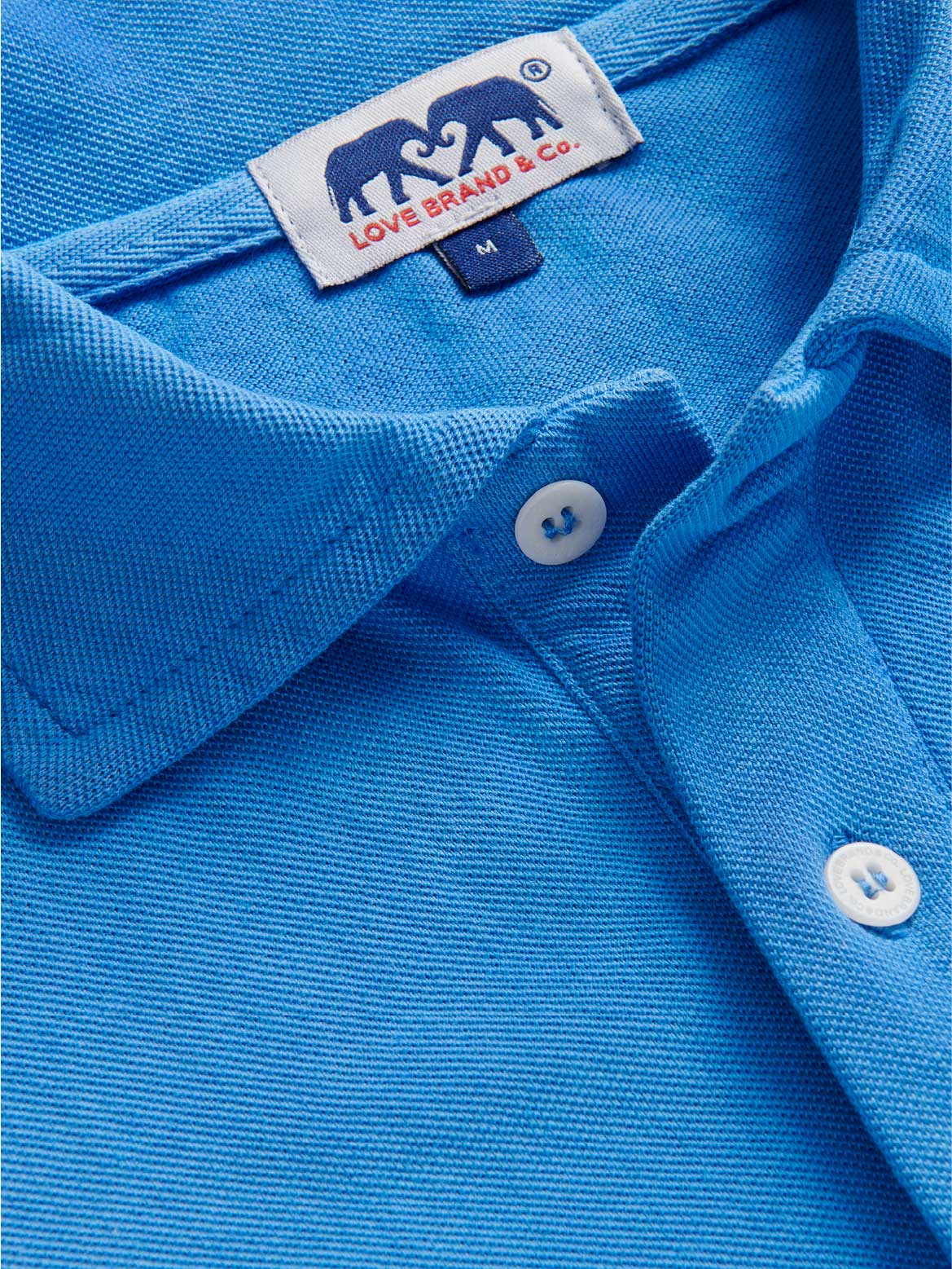Close-up of a blue polo shirt with a visible love brand label.