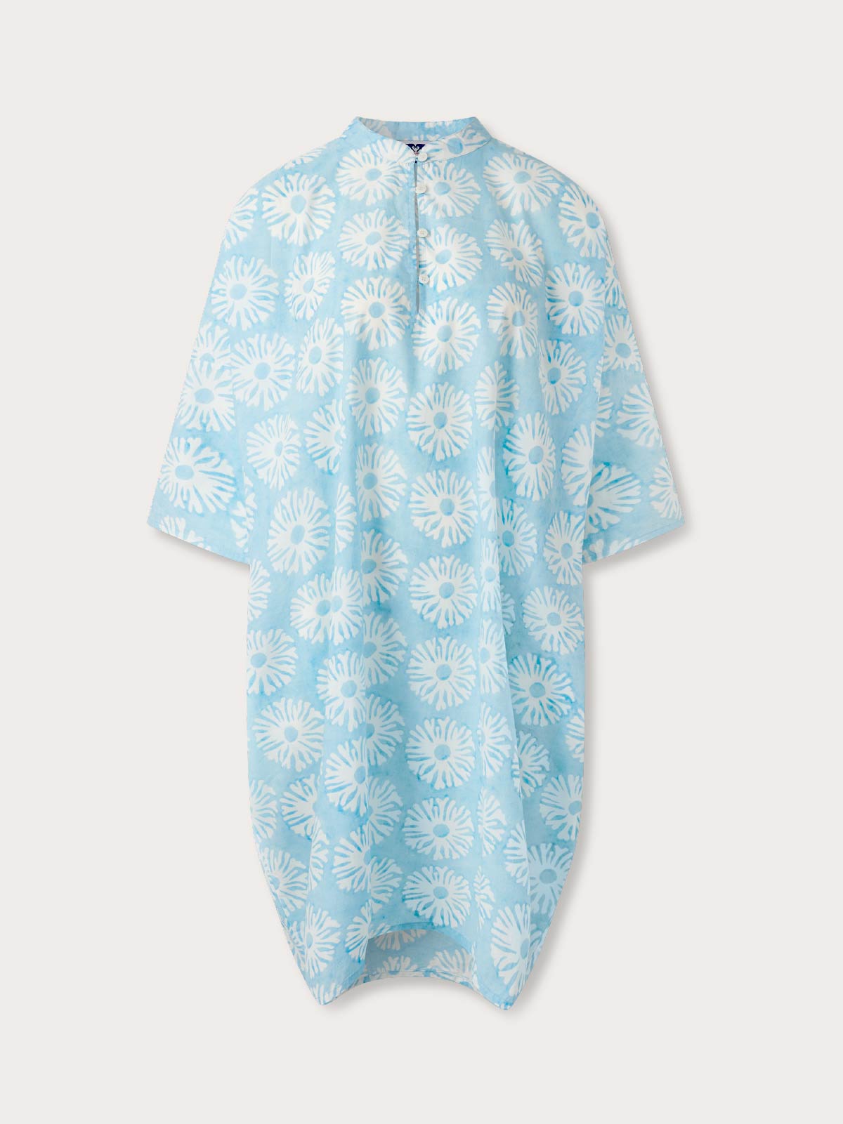 Light blue womens beach poncho with short sleeves and a white coral pattern.