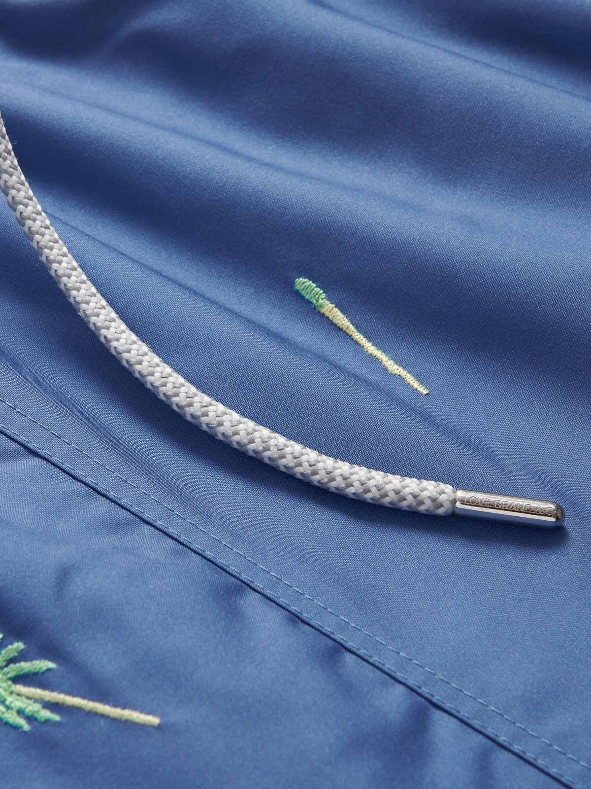 Men's Strike it Lucky Embroidered Staniel Swim Shorts by LOVE BRAND & Co. Blue swimming shorts with drawstring waist and pockets.