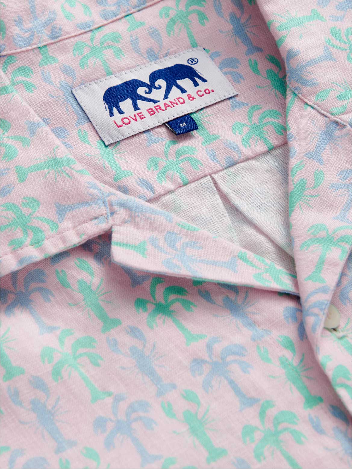 Pink shirt with palm tree pattern and Love Brand & Co. label