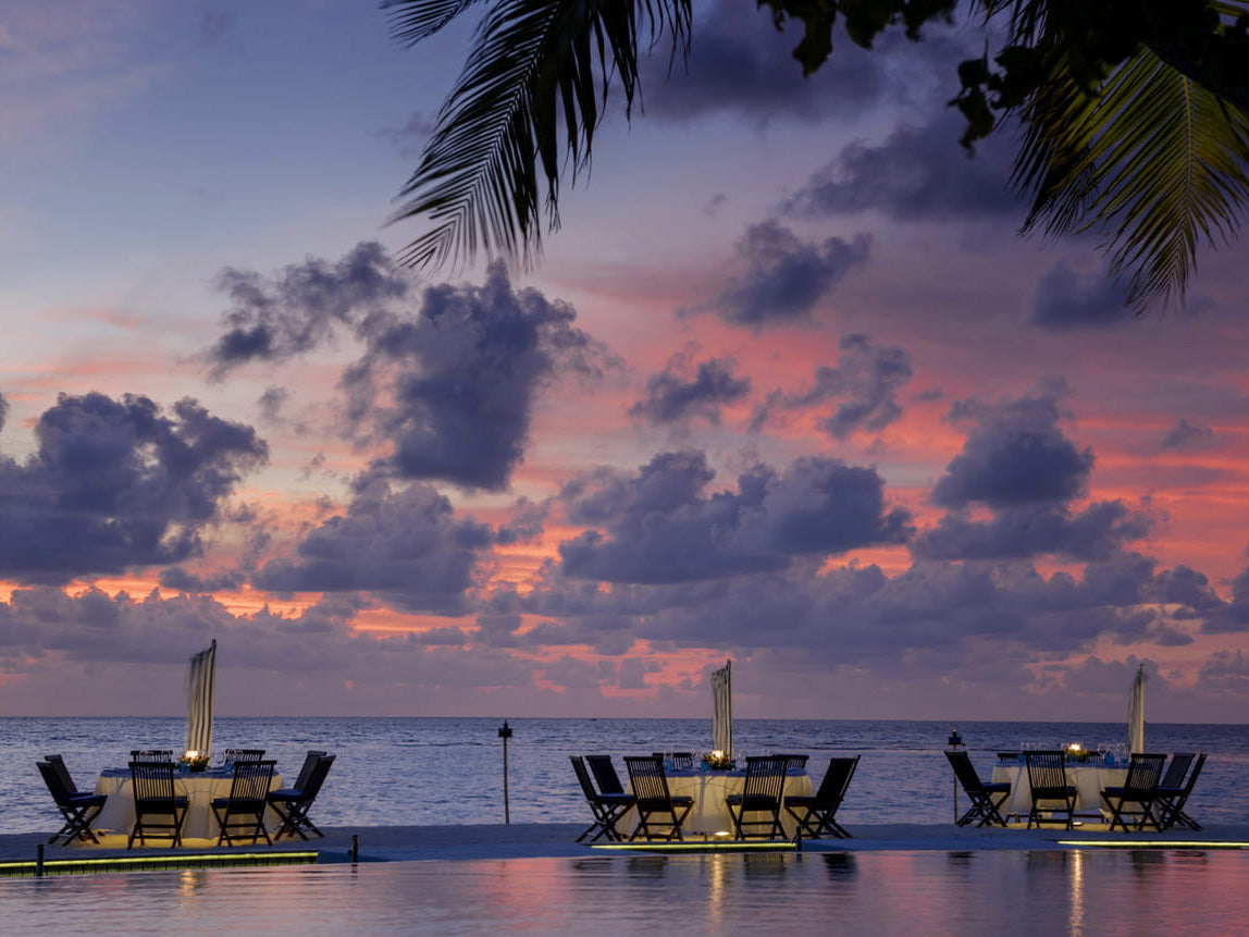 Four Seasons Maldives outdoor dining at sunset