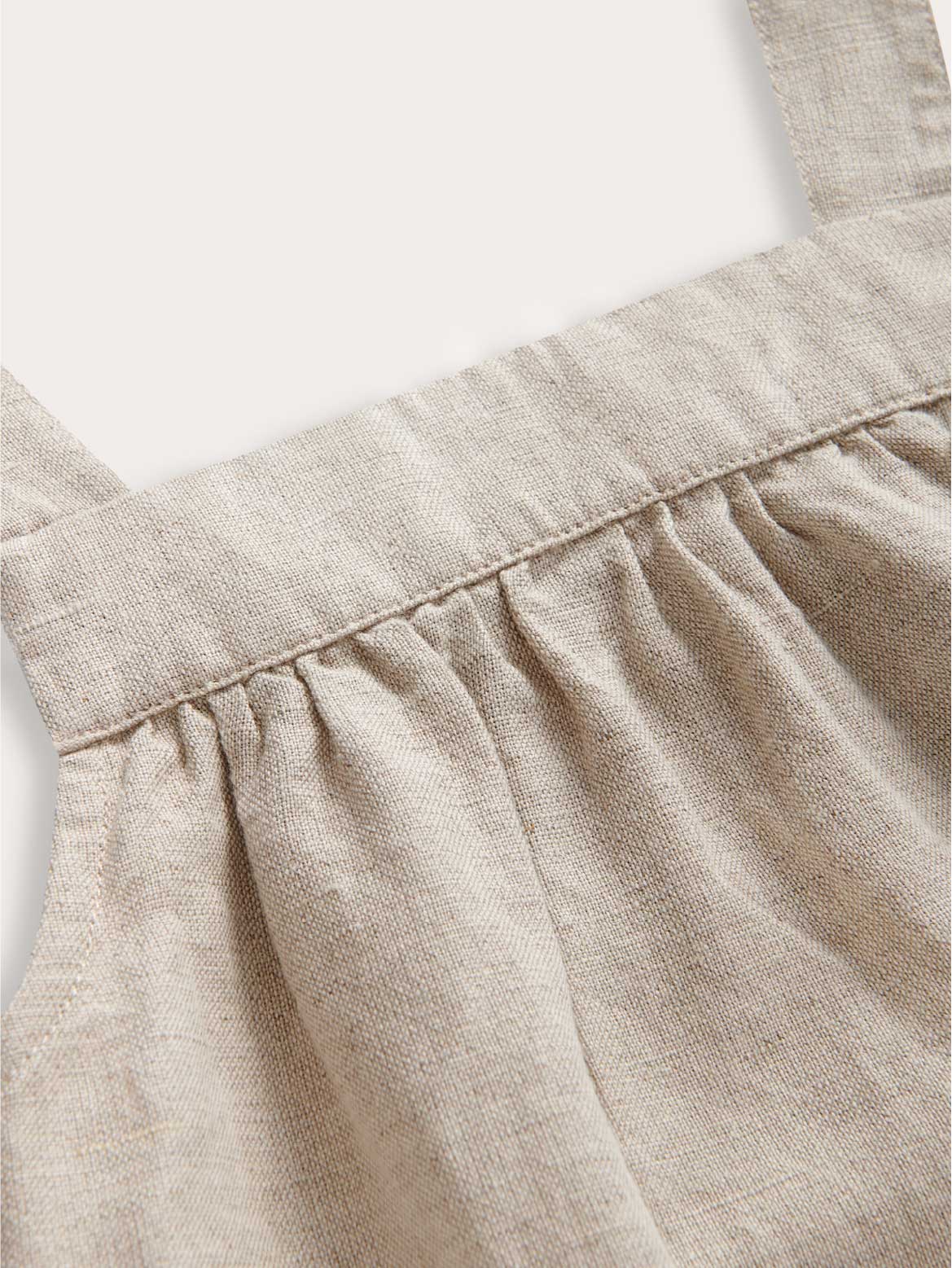 Close-up voew of kids ecru linen dress.