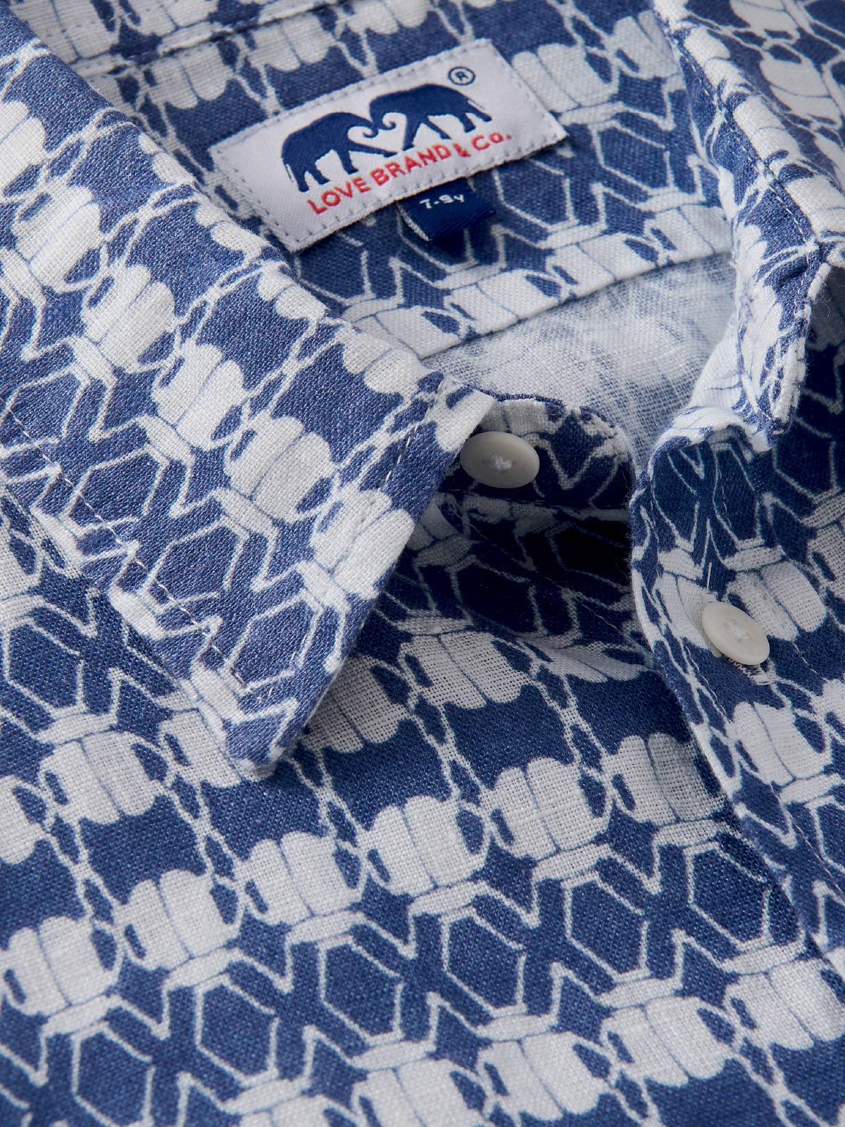 Close-up of a blue and white patterned shirt for children.