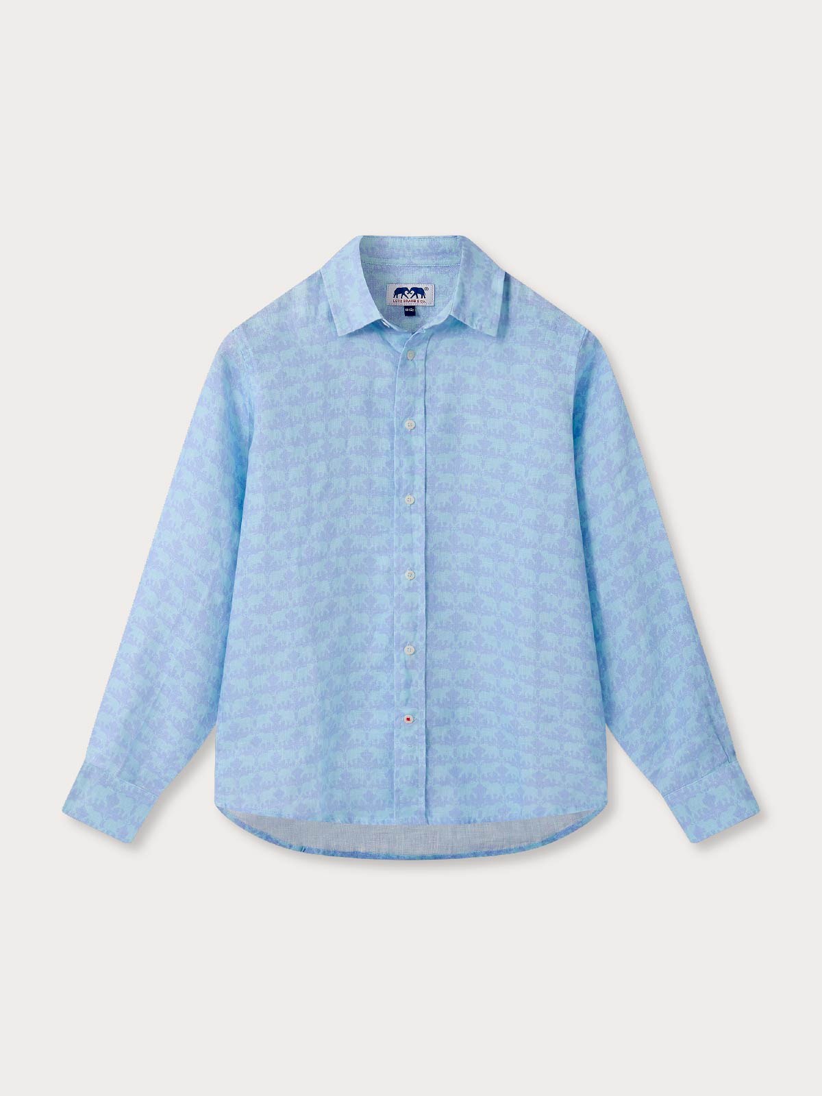 Light blue patterned linen shirt for kids. Button-up, long-sleeved childrens blue shirt on light background.