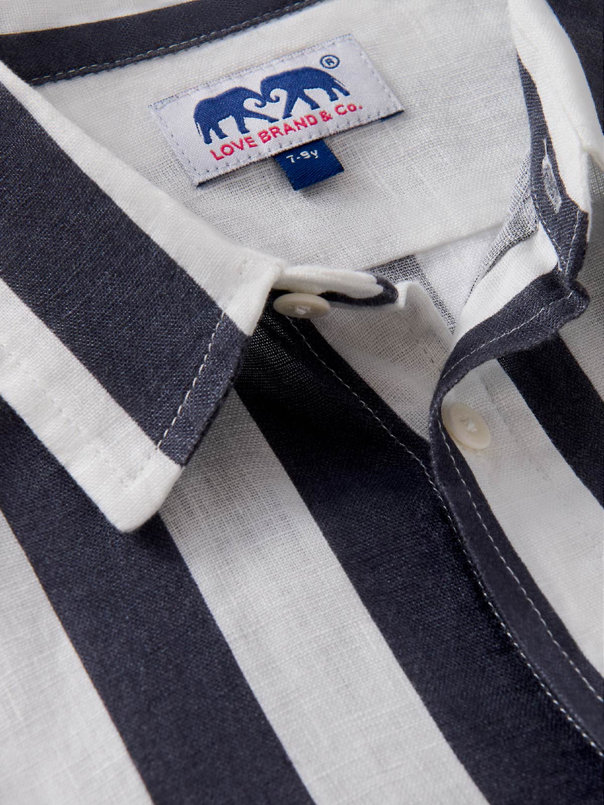 Close-up of a children's striped shirt with a visible love brand label.