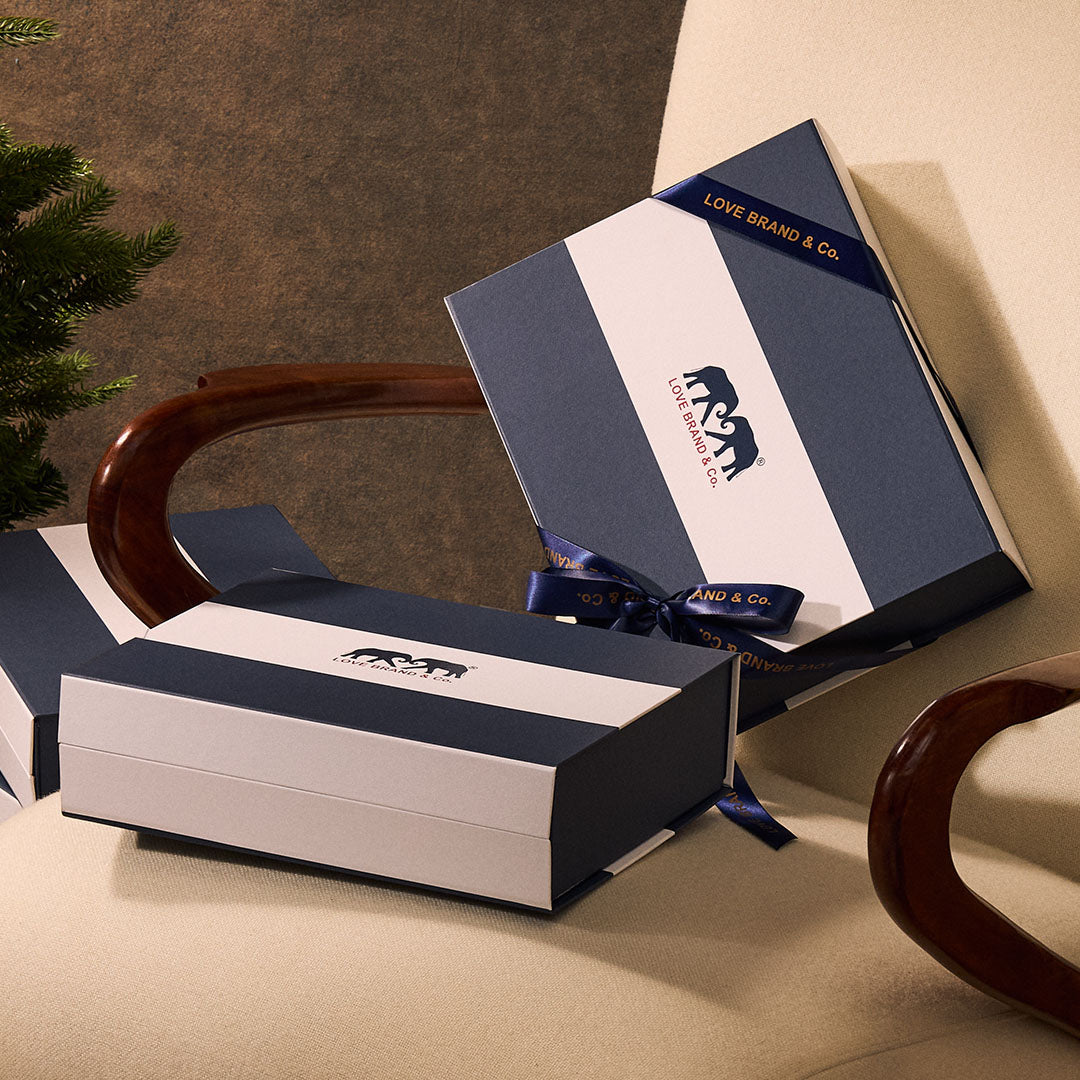 Two decorative boxes with a love brand logo on a textured surface.