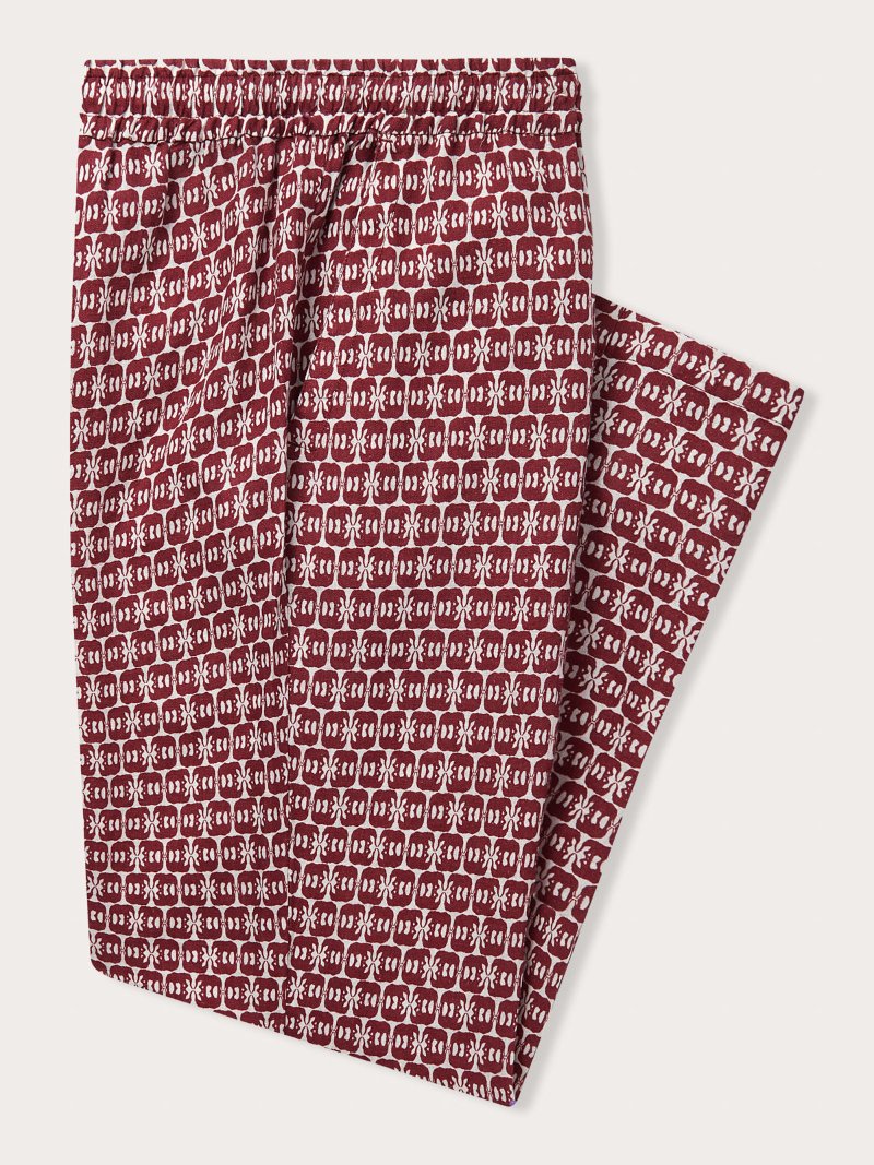 Men's Elephants of India Eleuthera Linen Trousers. Burgundy mens linen pants with white elephant print, featuring a drawstring waist and side pockets.