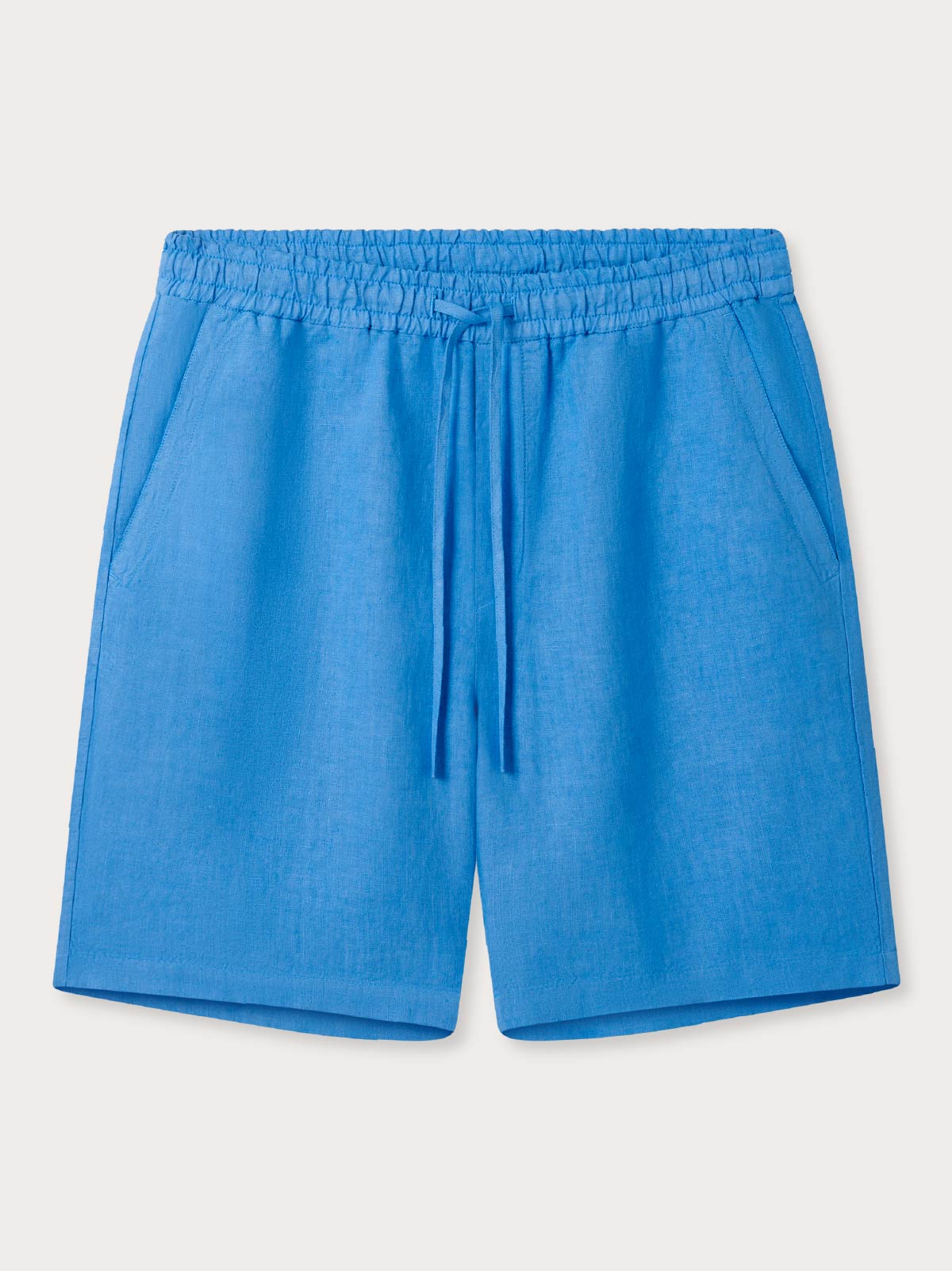 Blue linen shorts with a drawstring waist on a light grey background.