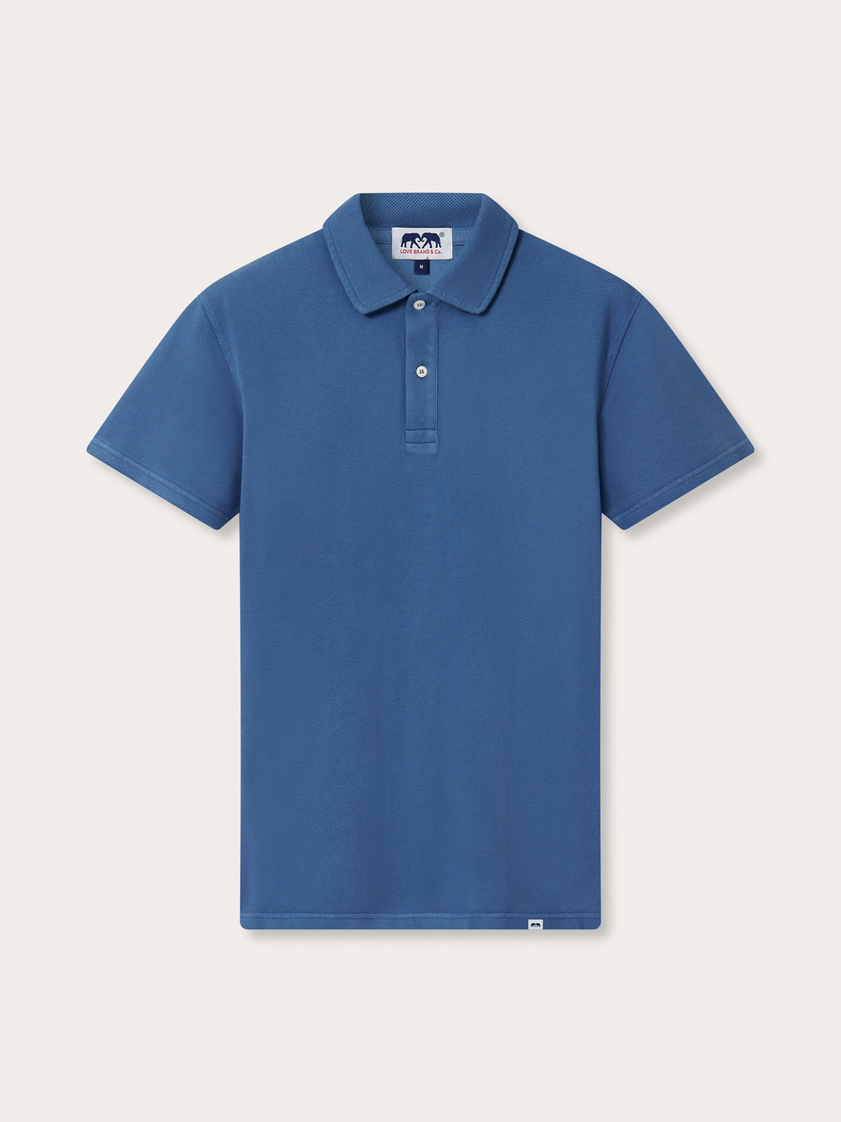 Blue polo shirt on a light gray background