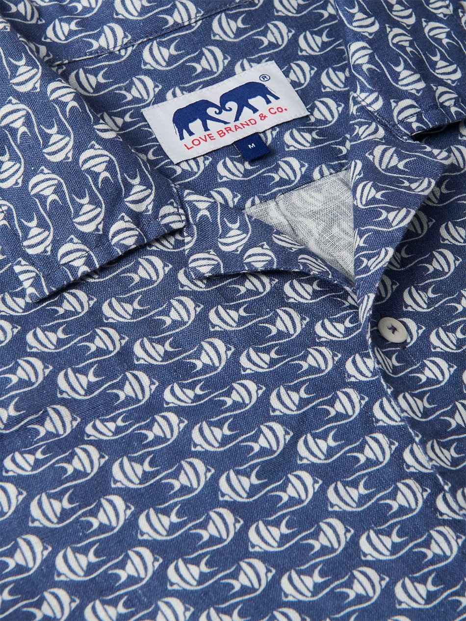 Go With the Flow Arawak mens Linen Shirt featuring a Moorish Idol fish print forming a wave pattern in blue and white.